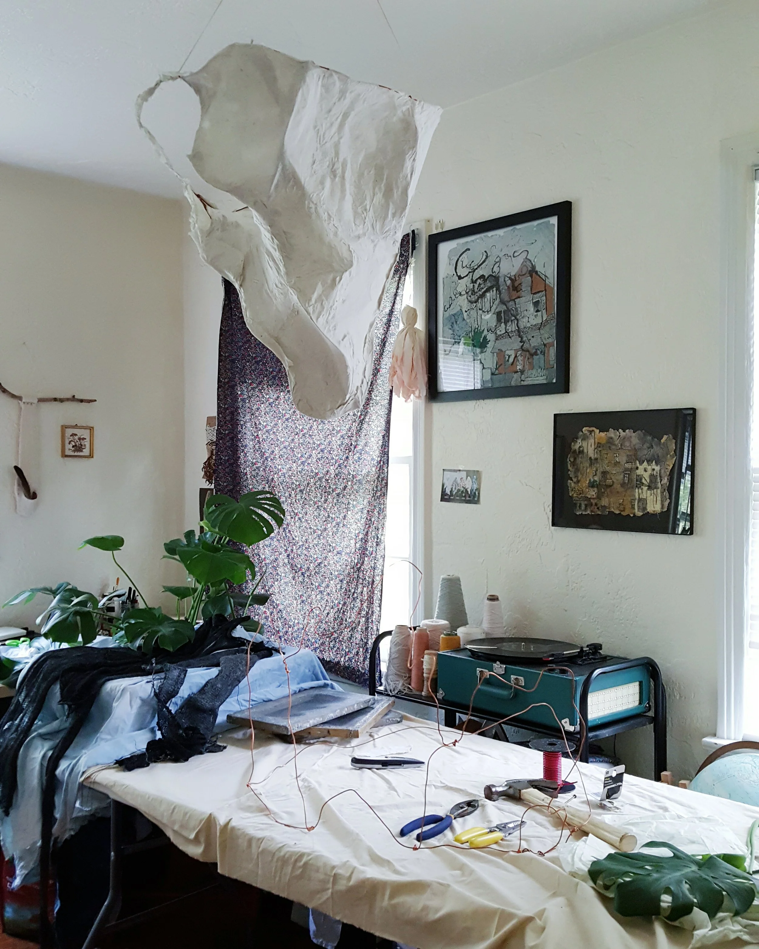 photo of piece being developed in the studio wire, handmade paper, machine knit pieces dipped in cornstarch, thread/yarn, and three rocks from the shore of lake michigan 2016 installation took place in gainesville, florida during unfurl, adjust, astir : curated by jessi hamilton