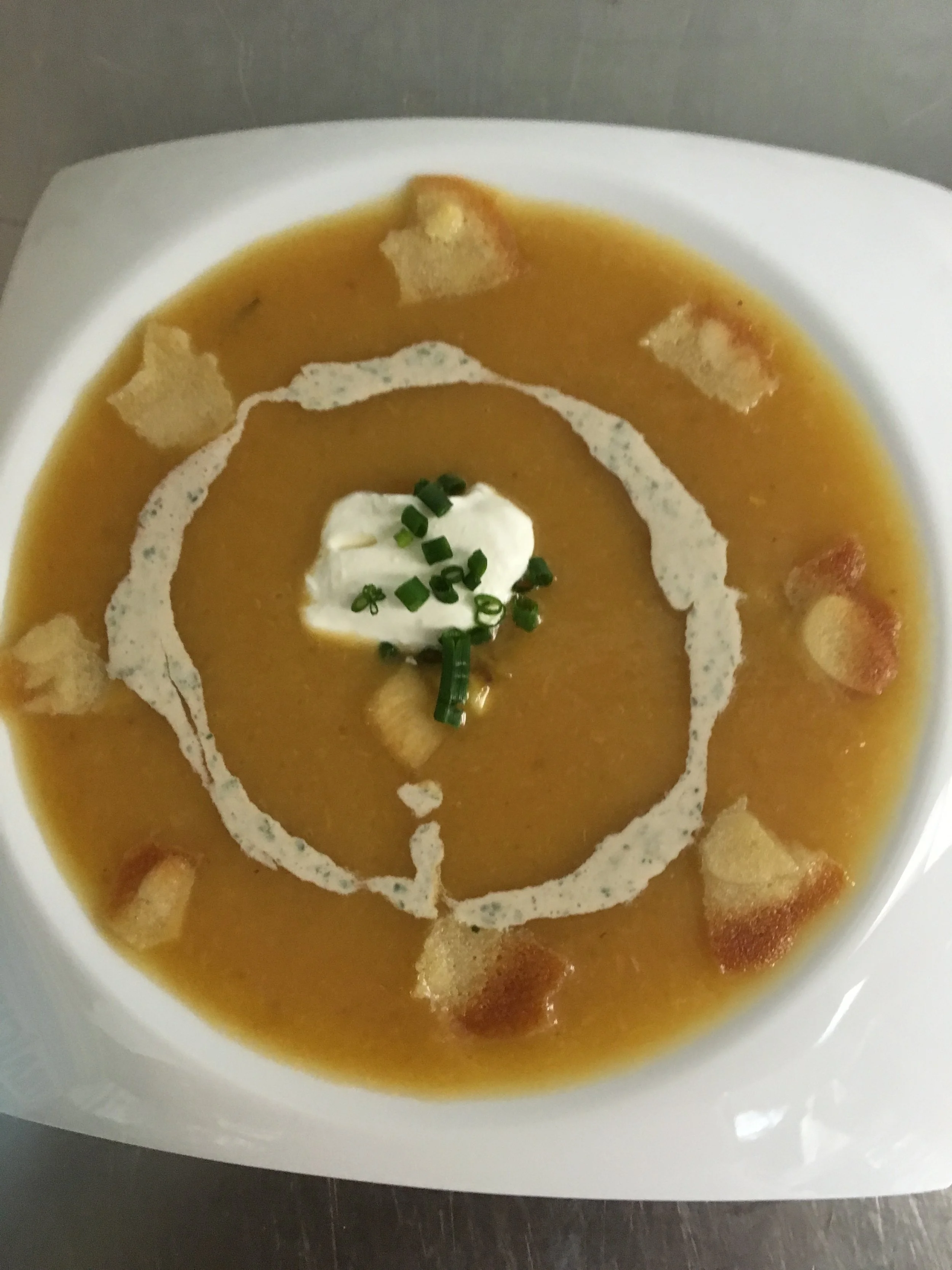 Peach and lemon grass soup Crème fraîche chive and mint drizzle