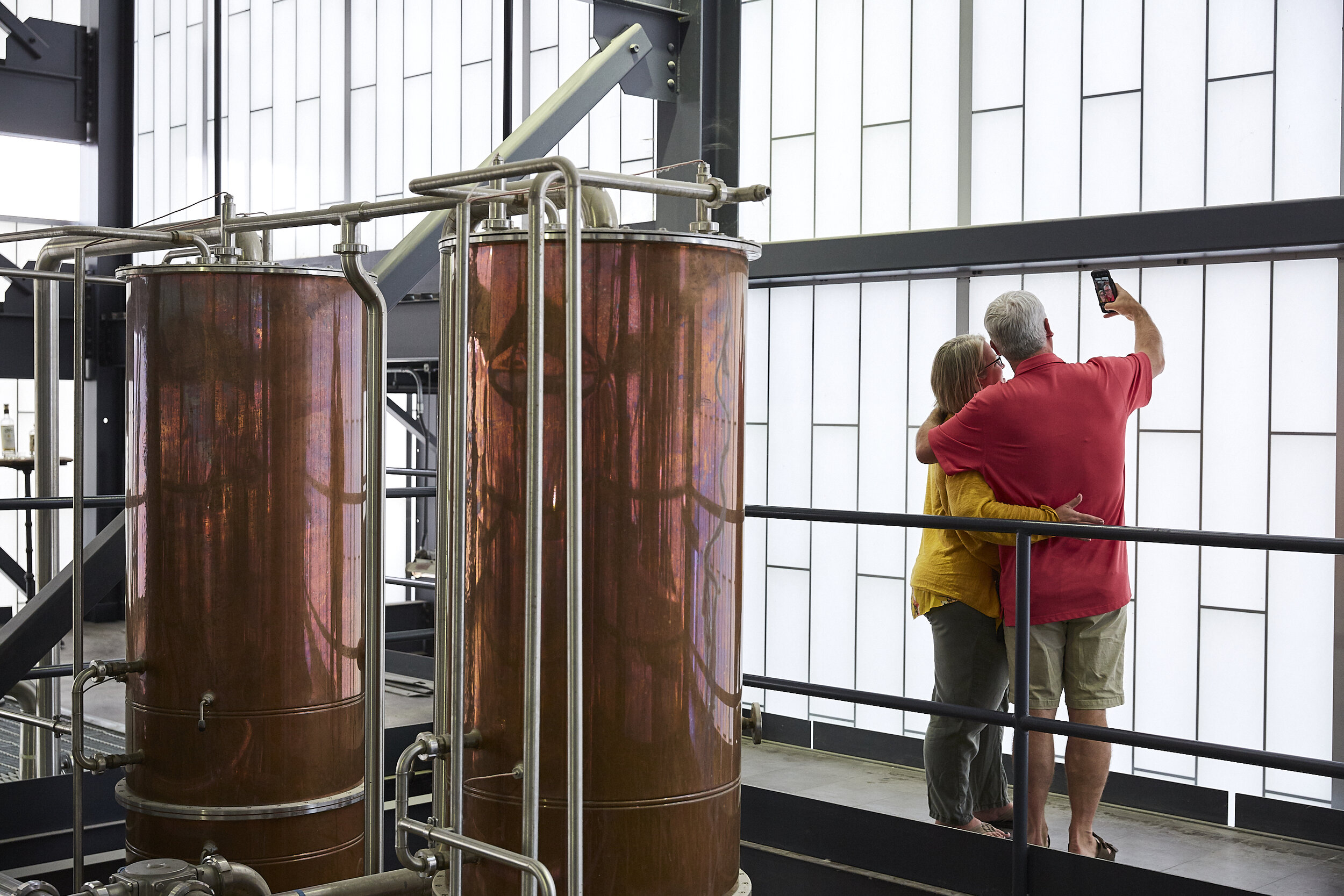 Distillery tour guests pose for a selfie ay Middle West Spirits. Photographed for The New York Times.