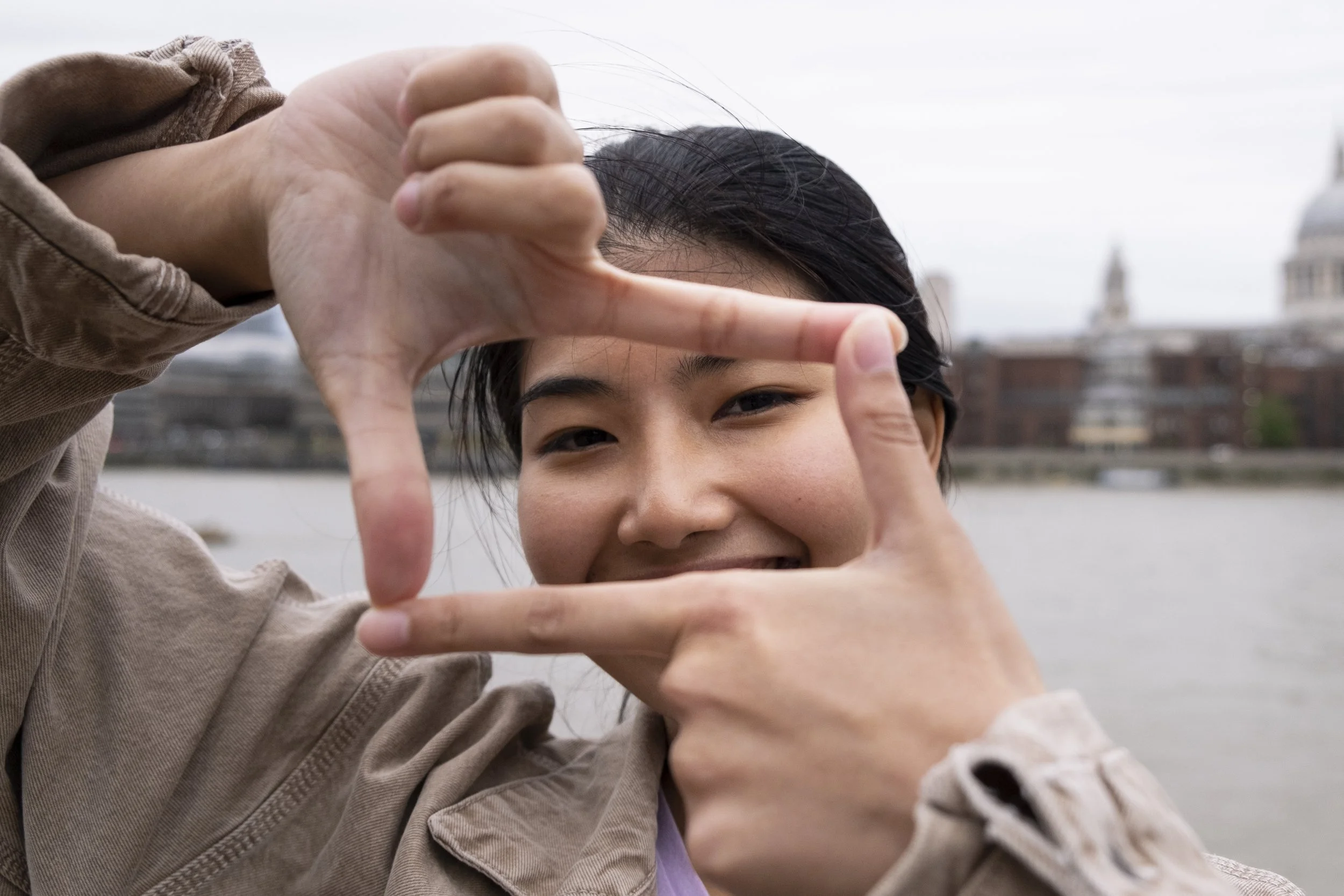 front-view-woman-making-camera-shape.jpg