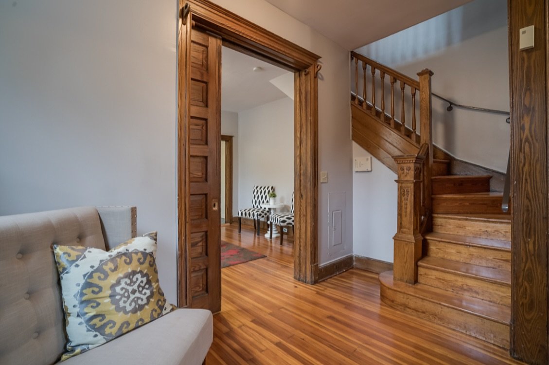There is something special about walking into a home and feeling its history in the details.
This project was all about honoring what was already here. The original staircase, pocket doors, and millwork were carefully preserved to keep the integrity