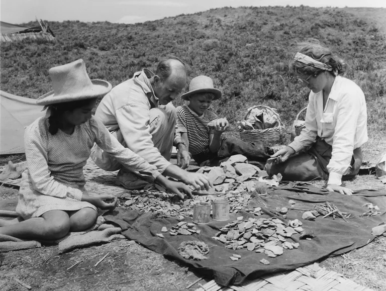 Elvira Sanchez, Junius Bird, Bob Bird, and Margaret (Peggy) Bird sorting material from sifters at Huaca Prieta, 1946-1947. Photo by John Collier