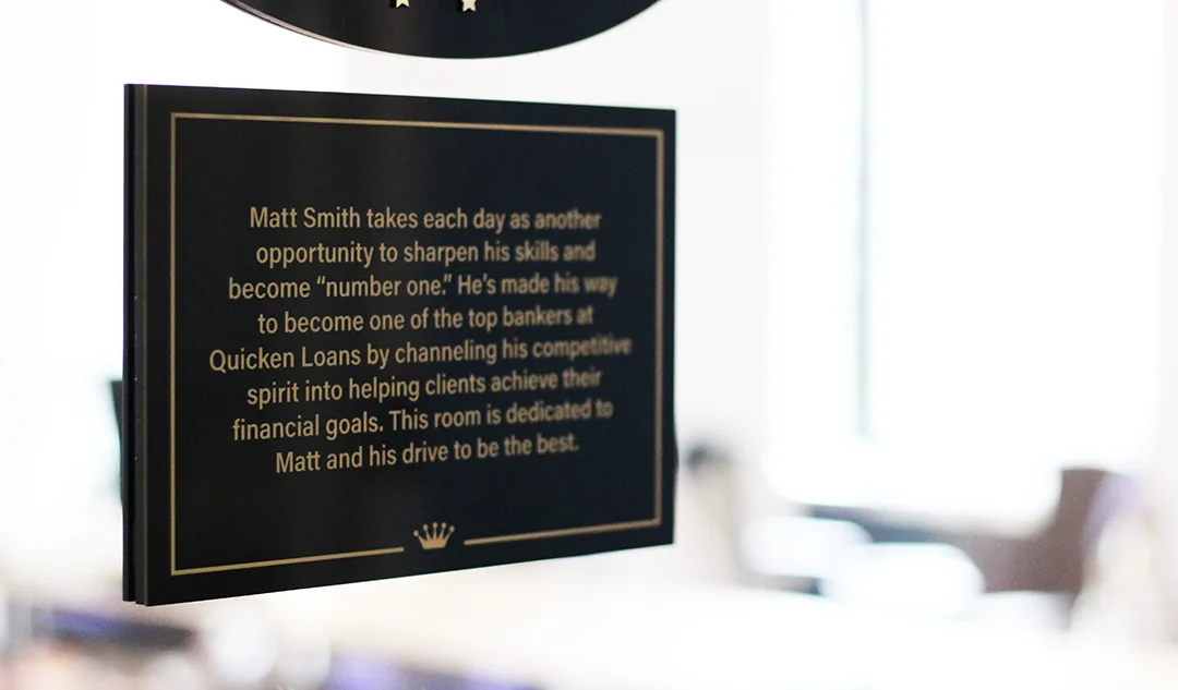 Conference Room Plaque In order to honor the best of the best, select conference rooms are named after team members. Underneath the conference room sign rests a plaque that gives you information about the team member the room is named after.