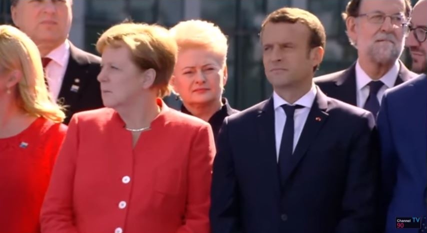 German Chancellor Angela Markel looks at the piece of the Berlin Wall at NATO headquarters in Brussels that was installed there along with a piece of the North Tower of the World Trade Center, May 25, 2017. To her left is newly elected President Emmanuel Macron of France, and behind her is Lithuania's President Dalia Grybauskaite, Croatia's President Kolinda Grabar-Kitarovic