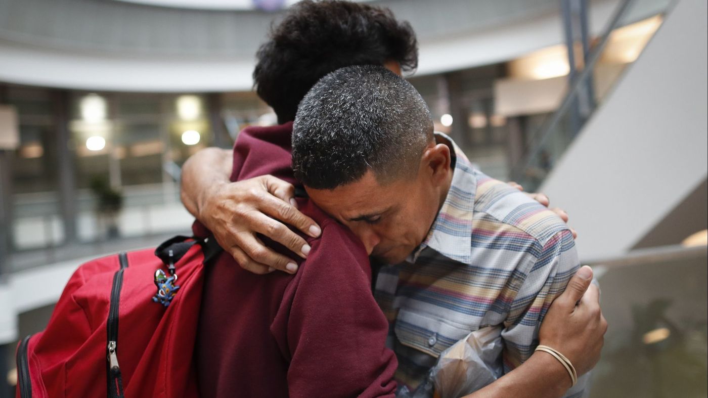 Edvin Cazun, right, and son Samuel of Guatemala reunite in Cincinnati on July 23, about a month after they were separated when they crossed the Rio Grande into the United States. (John Minchillo / Associated Press)