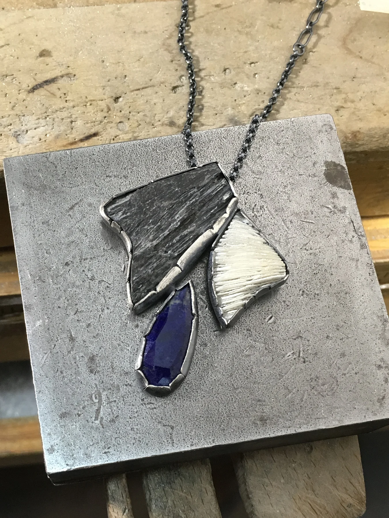 coral_kyanite_lapis_pendant_on_bench.jpg