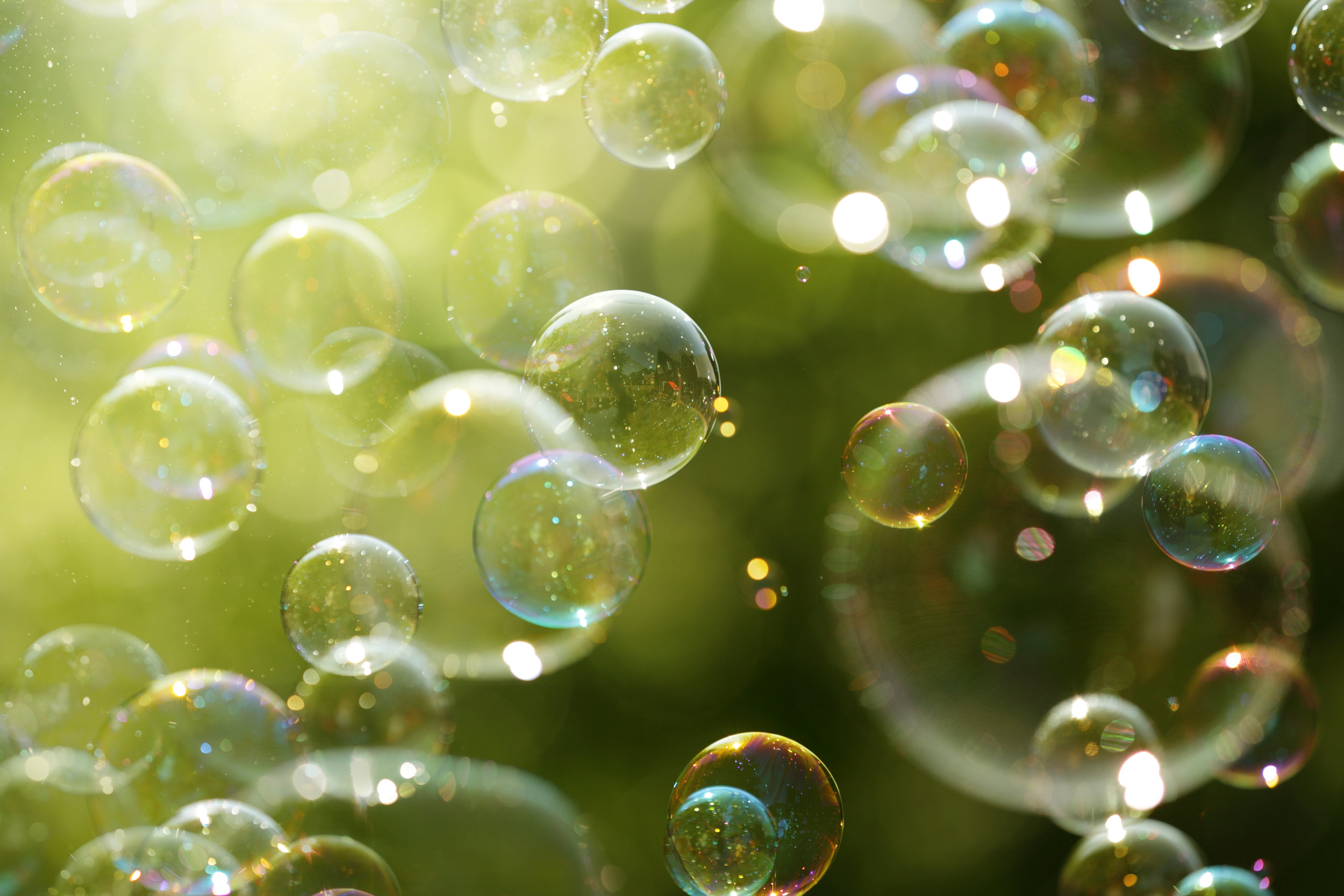 Soap bubbles floating in the air as the Summer sun sets