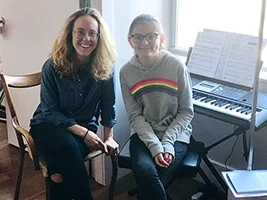 Piano teacher Sarah with her 11-year-old student Sofia at an in-home piano lesson in Brooklyn.
