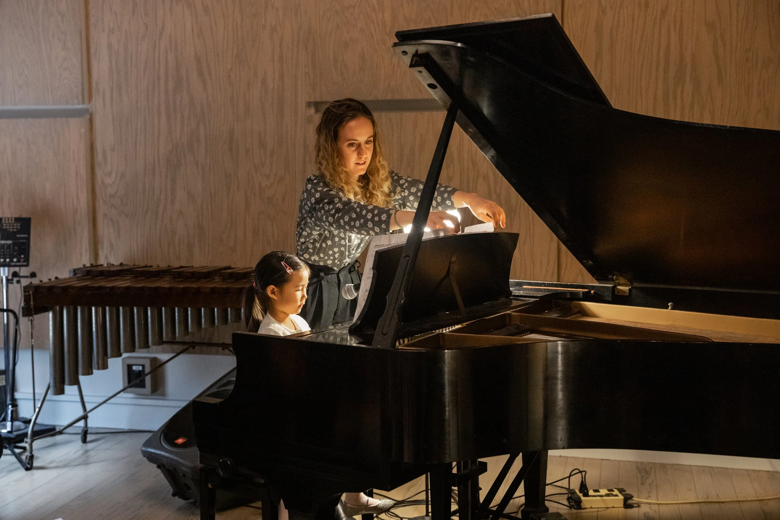 Student practicing piano in a studio during a personalized piano lesson.