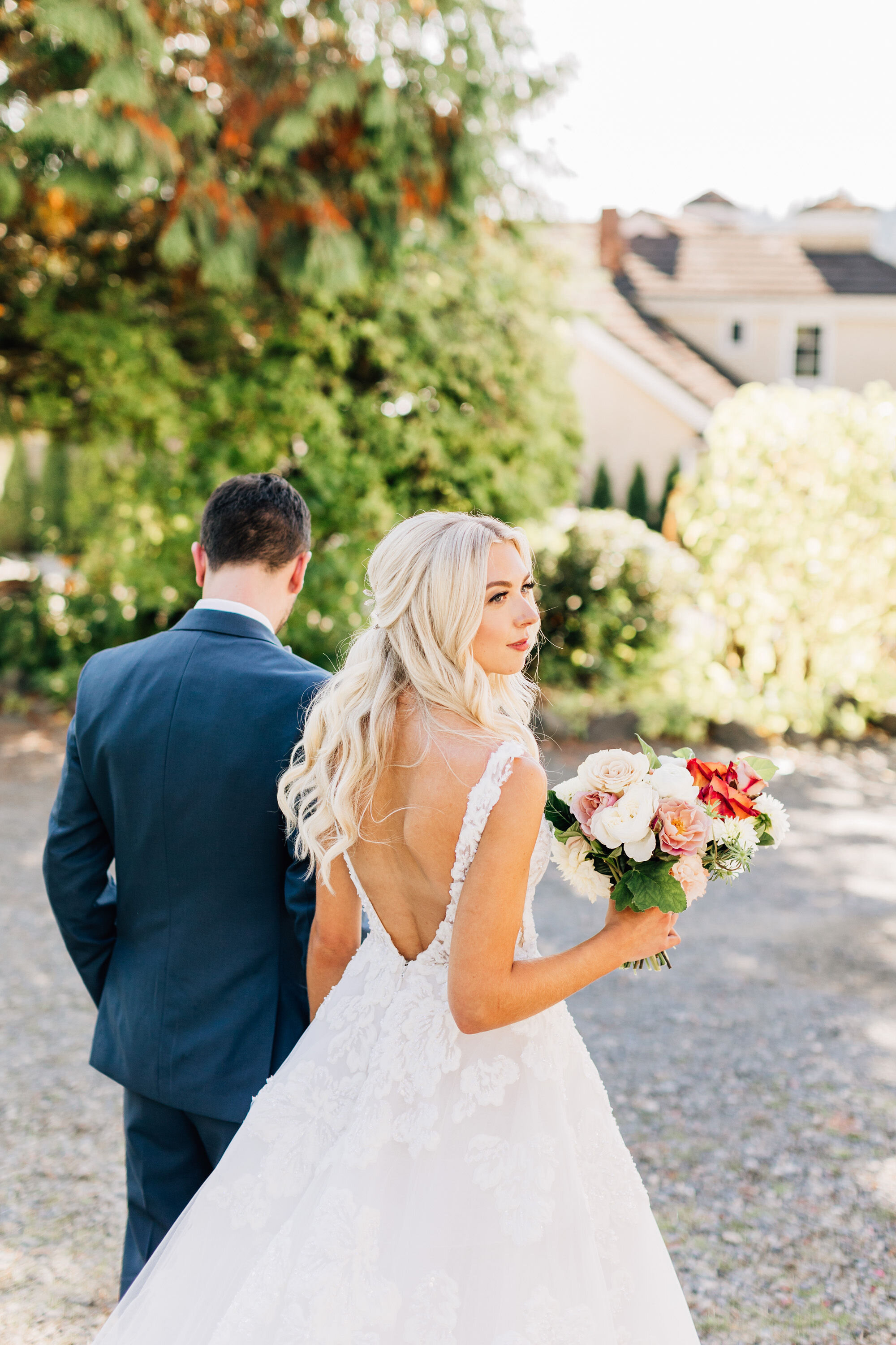  A Seattle bride and groom walking towards their wedding ceremony at Chateau Lill Winery in Woodinville, Washington. 