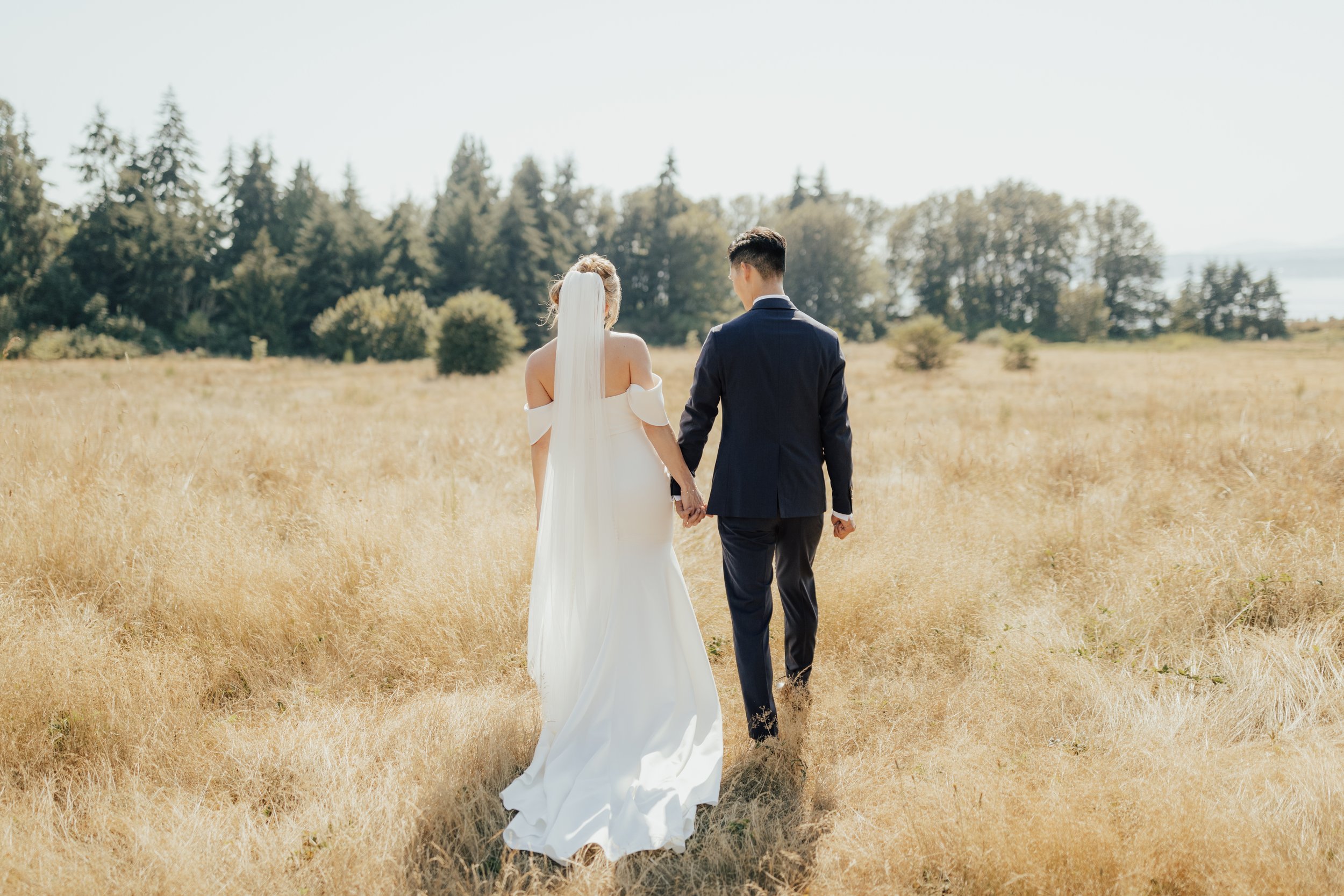 top-seattle-wedding-planner-pacific-engagements-discovery-park-wedding-portraits-bride-and-groom-walking-away-rachel-syrisko-photography
