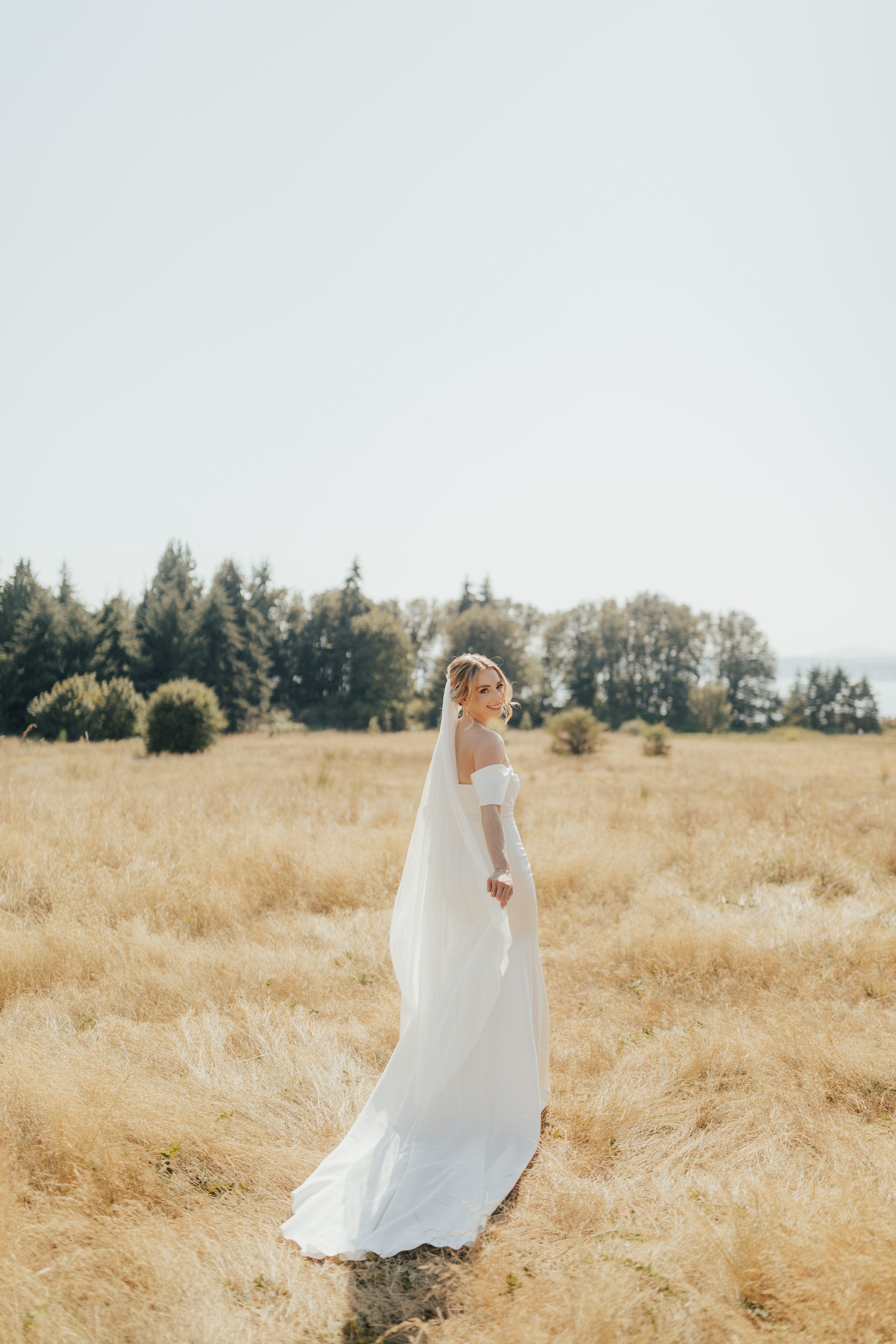 pacific-engagements-bride-looks-over-shoulder-in-discovery-park-seattle-rachel-syrisko-photography
