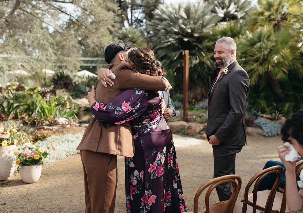 pacific-engagements-ruth-bancroft-gardens-wedding-photos-of-groom-hugging-mom-during-ceremony-sam-minter-photography