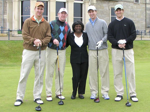 Renee Powell with famous football family, The Manning's in front of R & A in Scotland. 