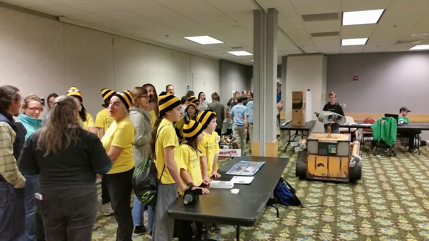FLL team members watch the FRC robot demos 
