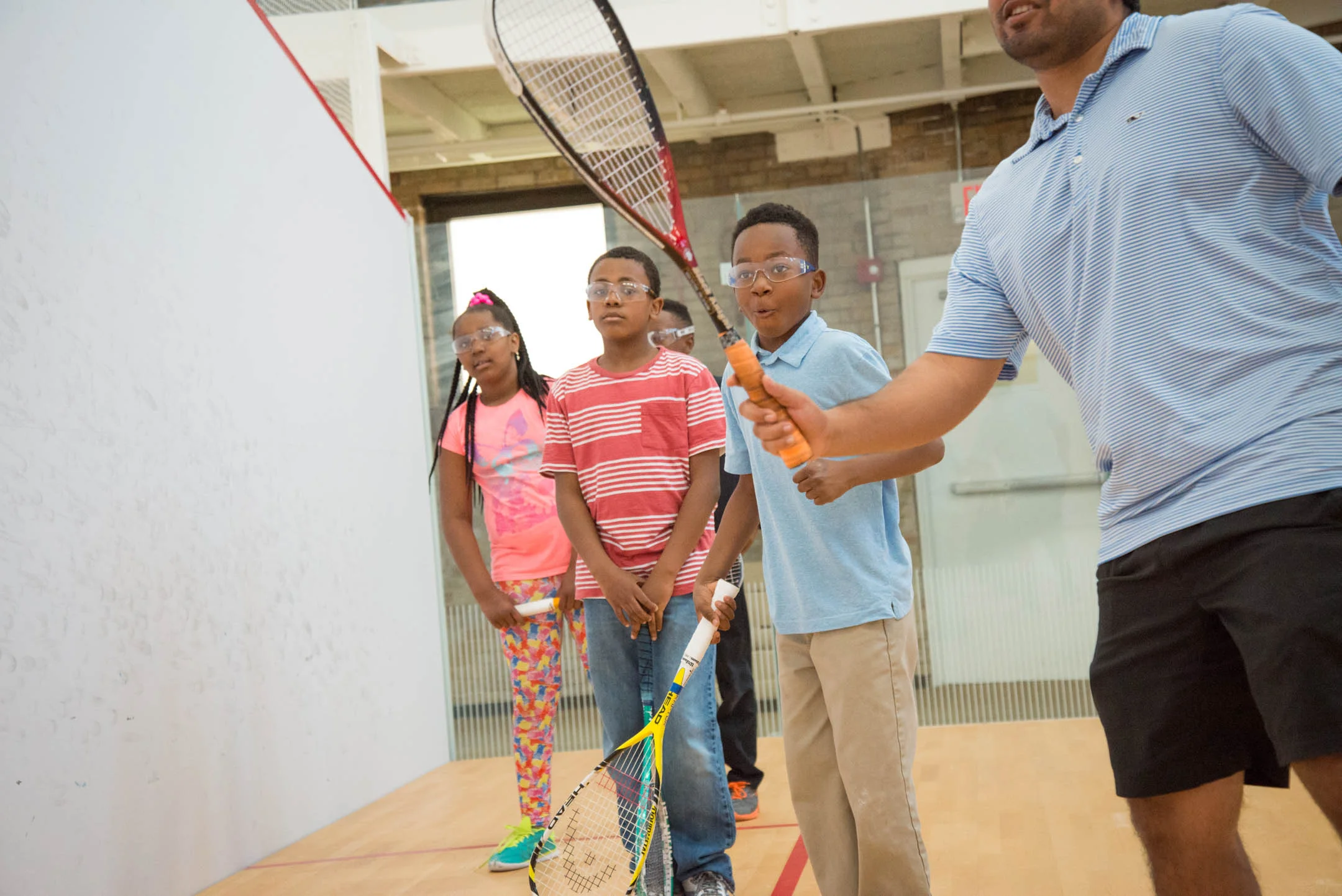 Kids of the Cincinnati Squash Academy watch as Coach Vir Seth show them techniques during practice Monday May 8, 2017.