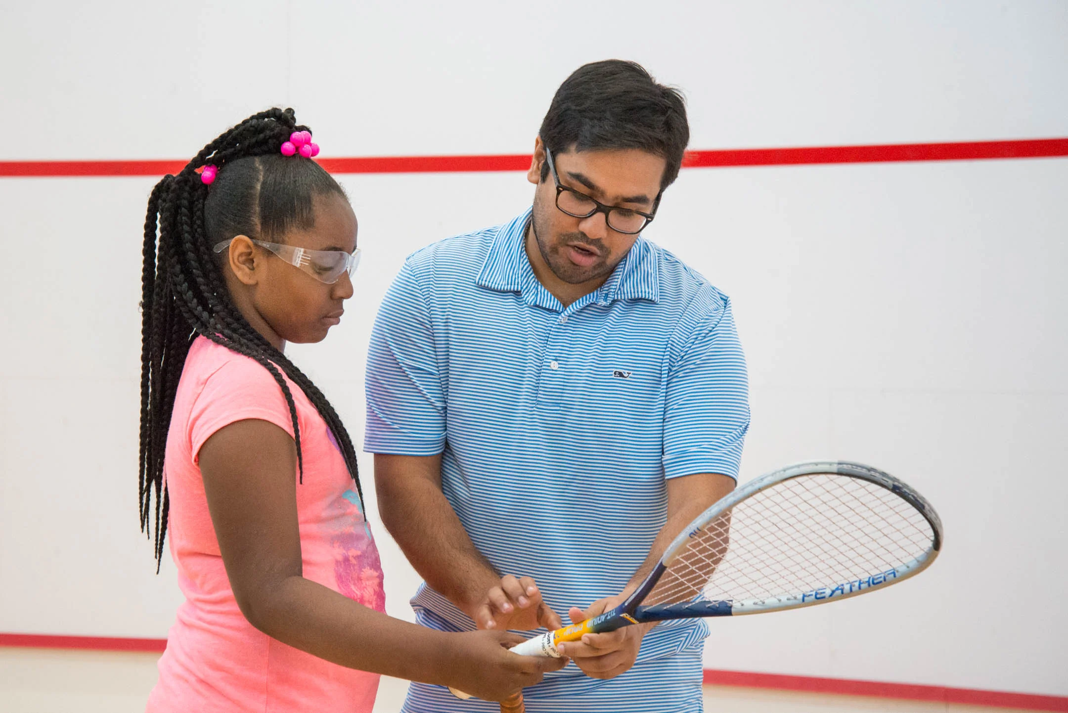 Coach Vir Seth helps Katie Whitt through proper technique during practice at the Cincinnati Squash Academy Monday May 8, 2017.