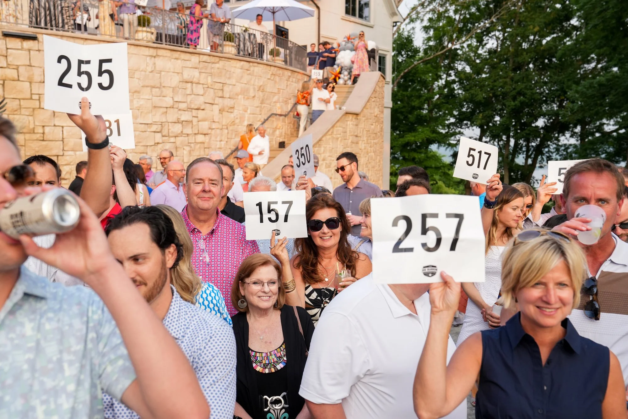  Bidders raise their paddles during the live-auction at the after party of the Inaugural Joe Burrow Foundation Golf Invitational Monday, June 5, 2023. Nearly one million dollars was raised to provide resources and support to the underprivileged and t