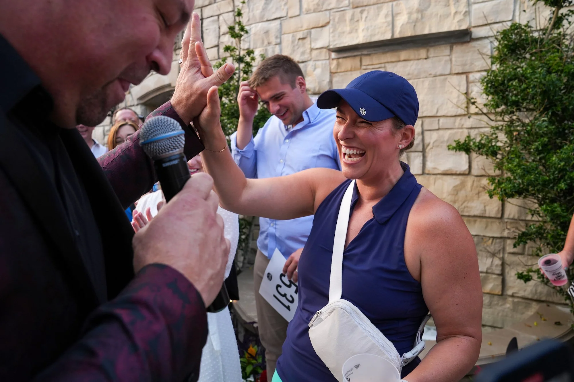  A Bidder celebrates her win during the live-auction at the after party of the Inaugural Joe Burrow Foundation Golf Invitational Monday, June 5, 2023. Nearly one million dollars was raised to provide resources and support to the underprivileged and t