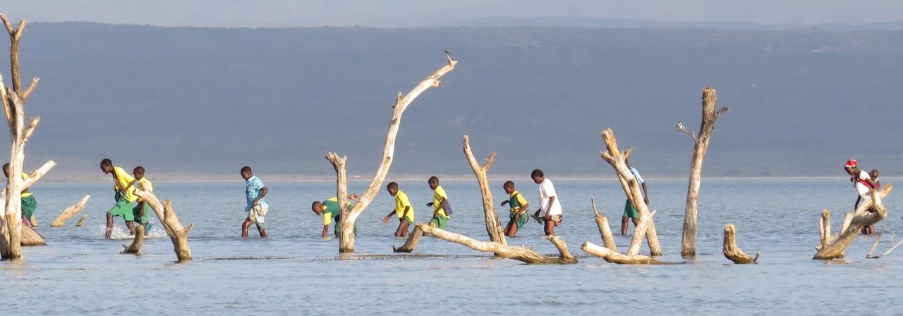 Students cross the lake on their way home from Kokwa Primary School