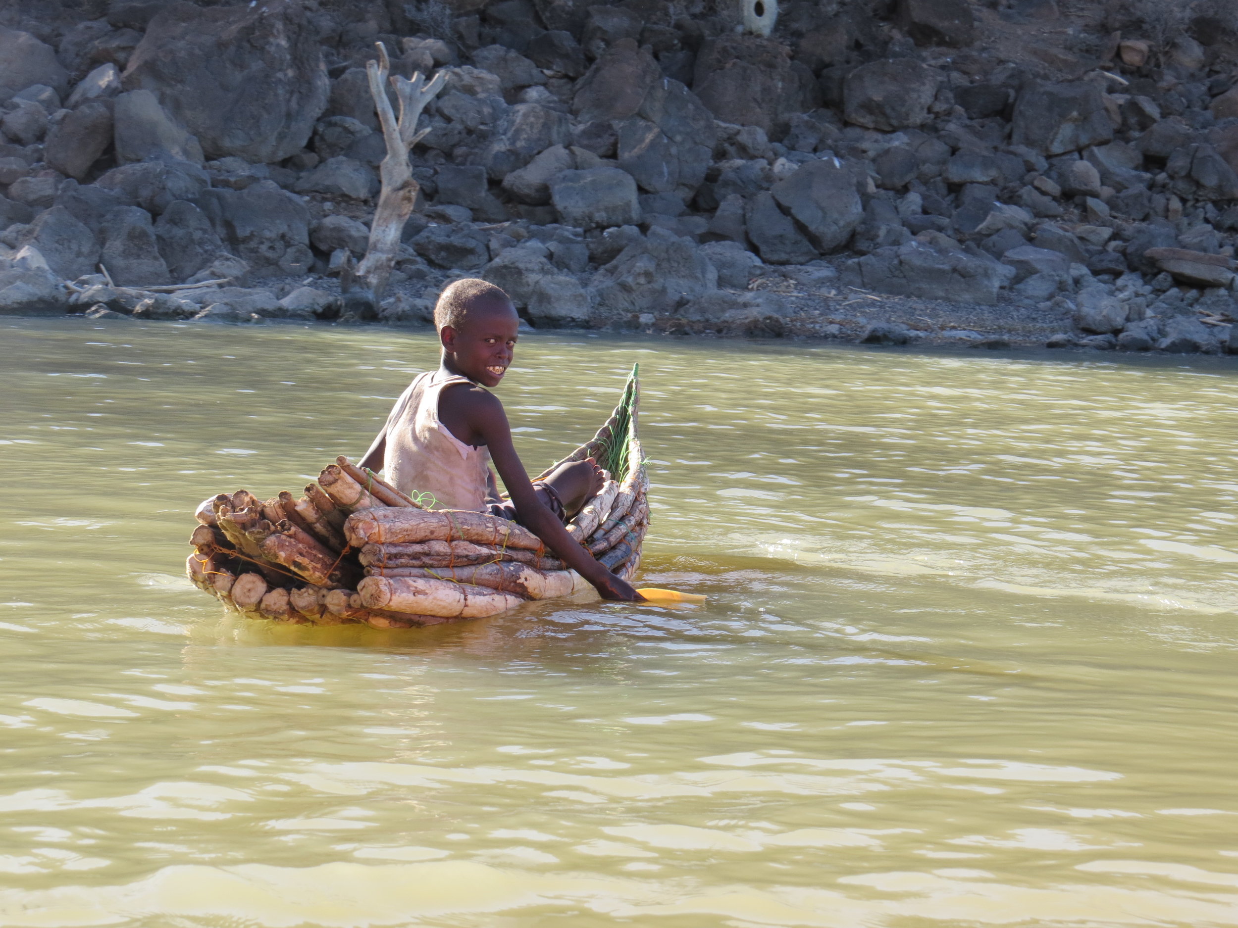 Il Chamus boy paddling his canoe in Lake Baringo