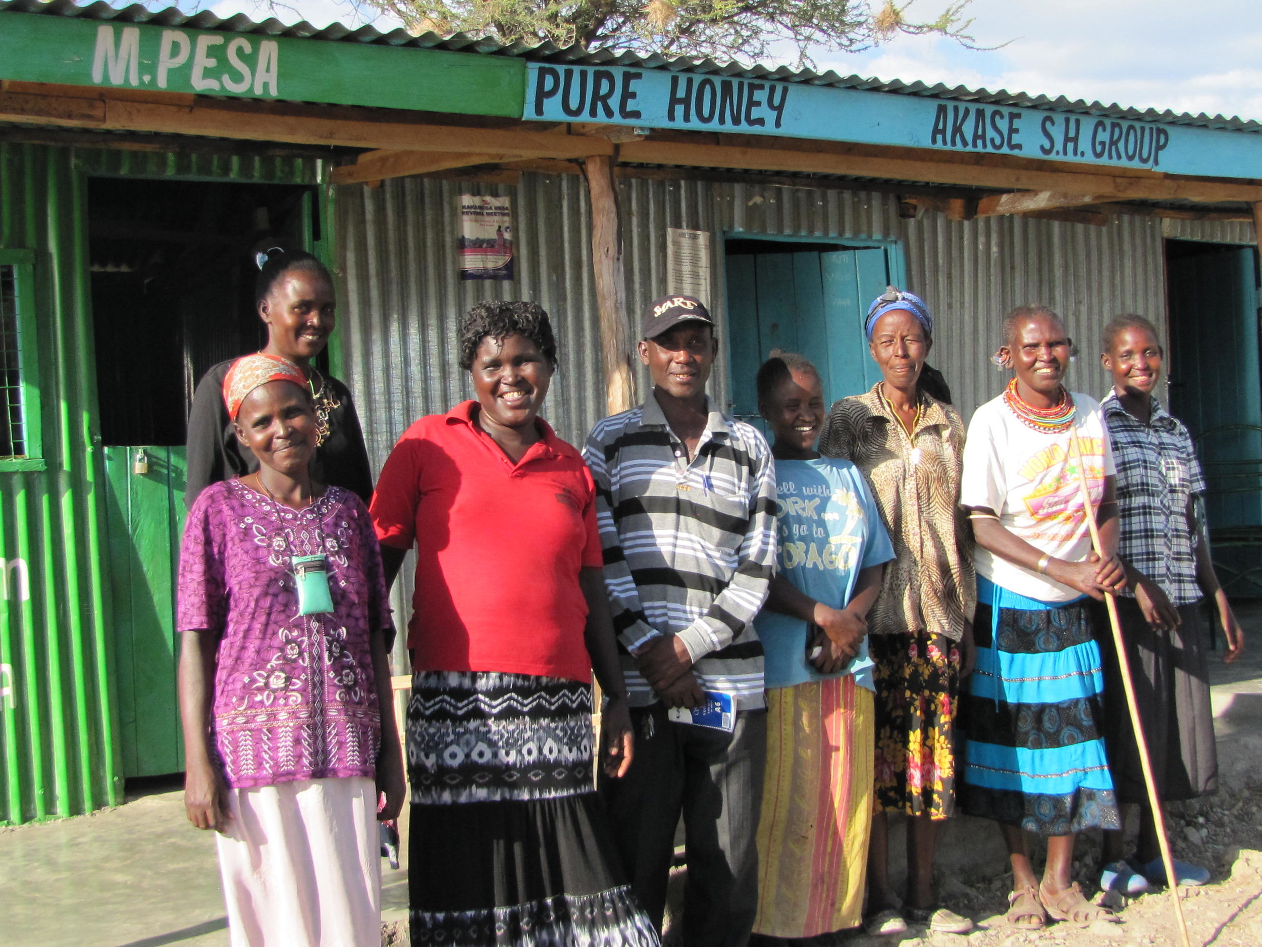 AKASE Self-Help Group in front of their place of business