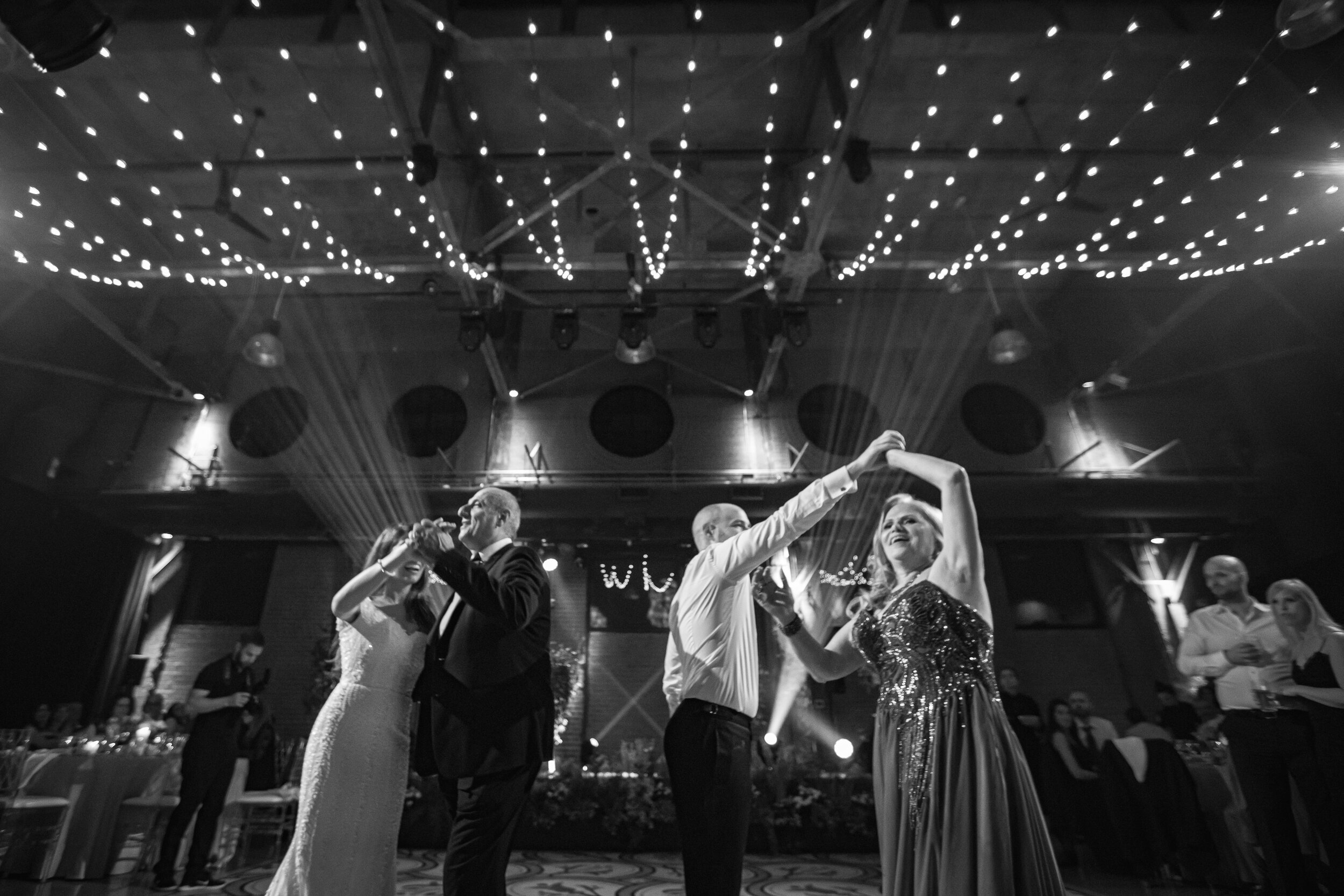 Toronto-photographer-wedding-decor-bride-groom-symes-malta-themed-candles-floral-flowers-sole-power-music-Hora-Jewish-Horah-son-mom-dance