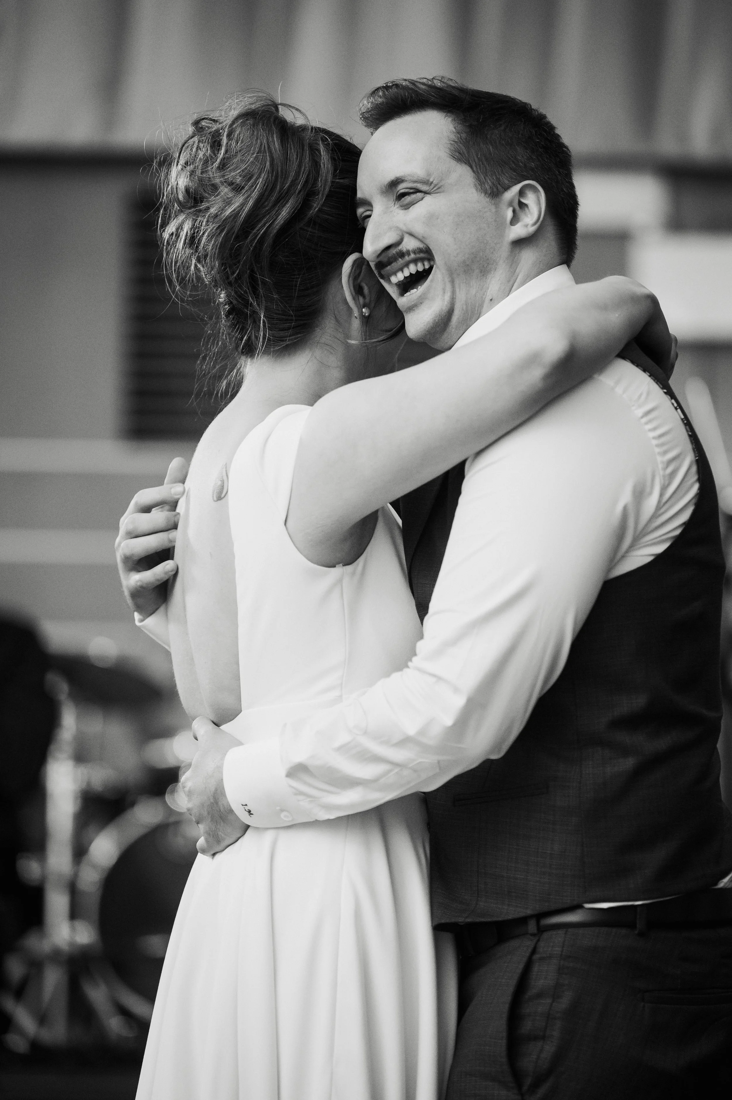 Groom laughing during first dance