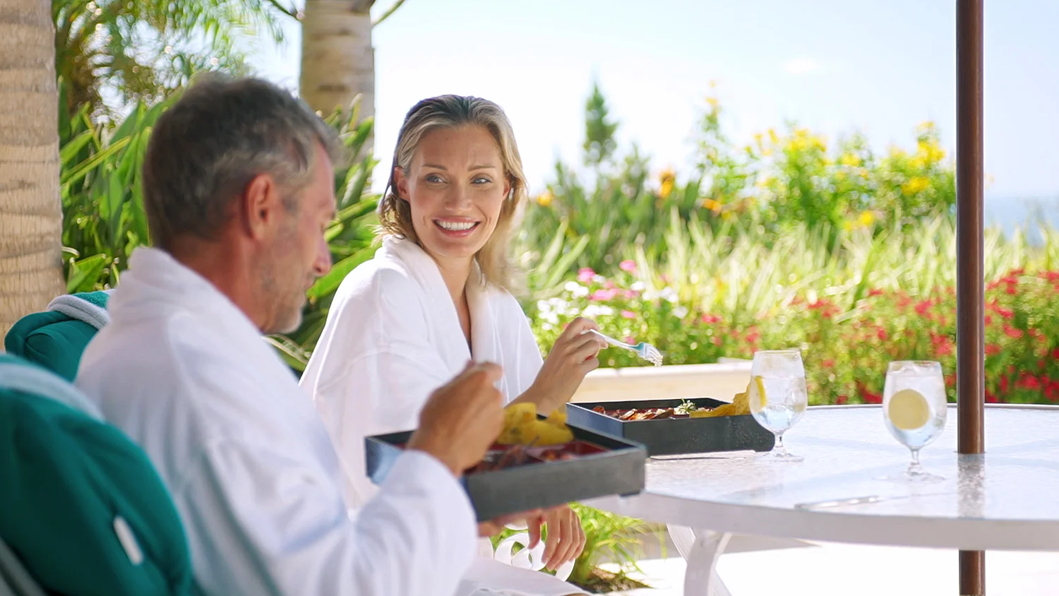 Couple in robes having spa breakfast