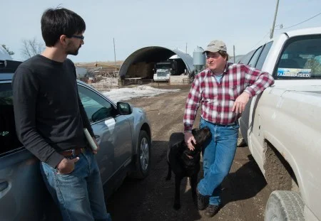 Nathanael Johnson (left) visits with Dave Strutterhs at his farm near Collins, Iowa.