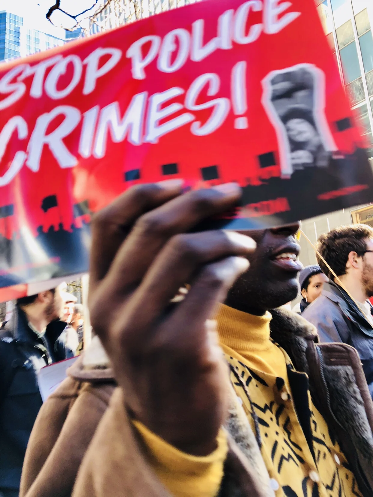 A man holds a sign protesting police crimes in Chicago, Illinois.