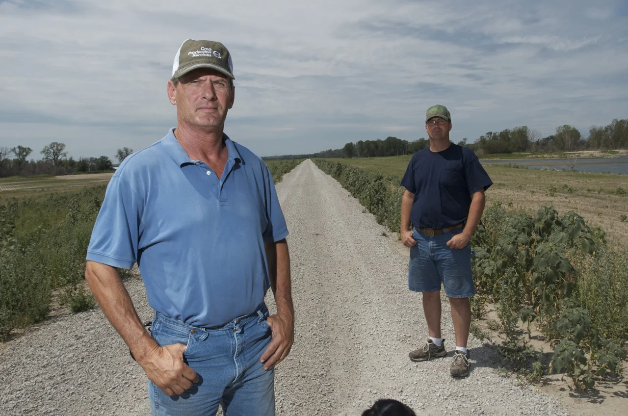 Leo Ettleman and Jeff Jorgenson stand on a recently rebuilt levee near the Missouri River. The U.S. Army Corps of Engineers repaired the levees back to the original flood protection giving residents the security to rebuild their farms and homes. (Ph…