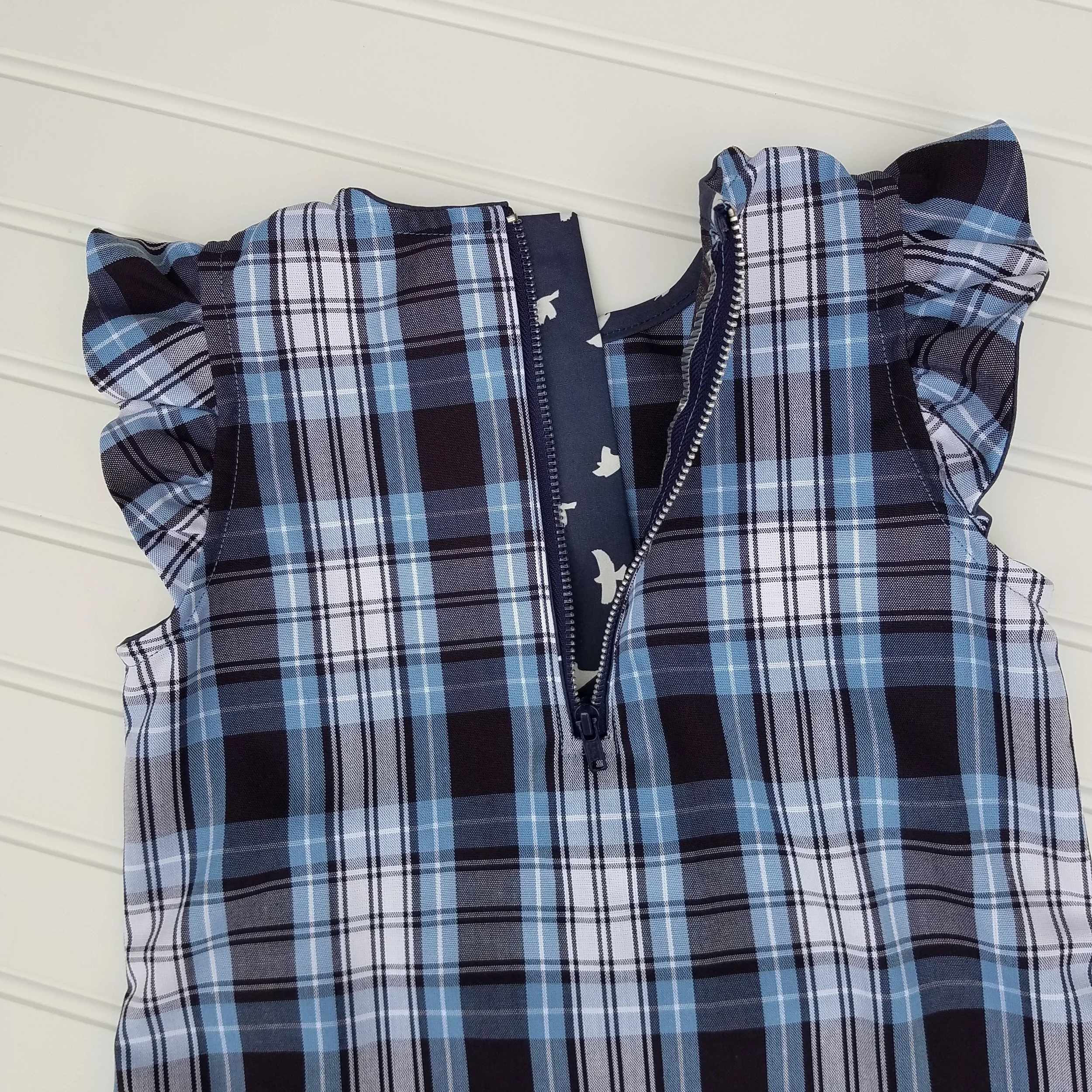 Back features an exposed zipper with optional zip guard.