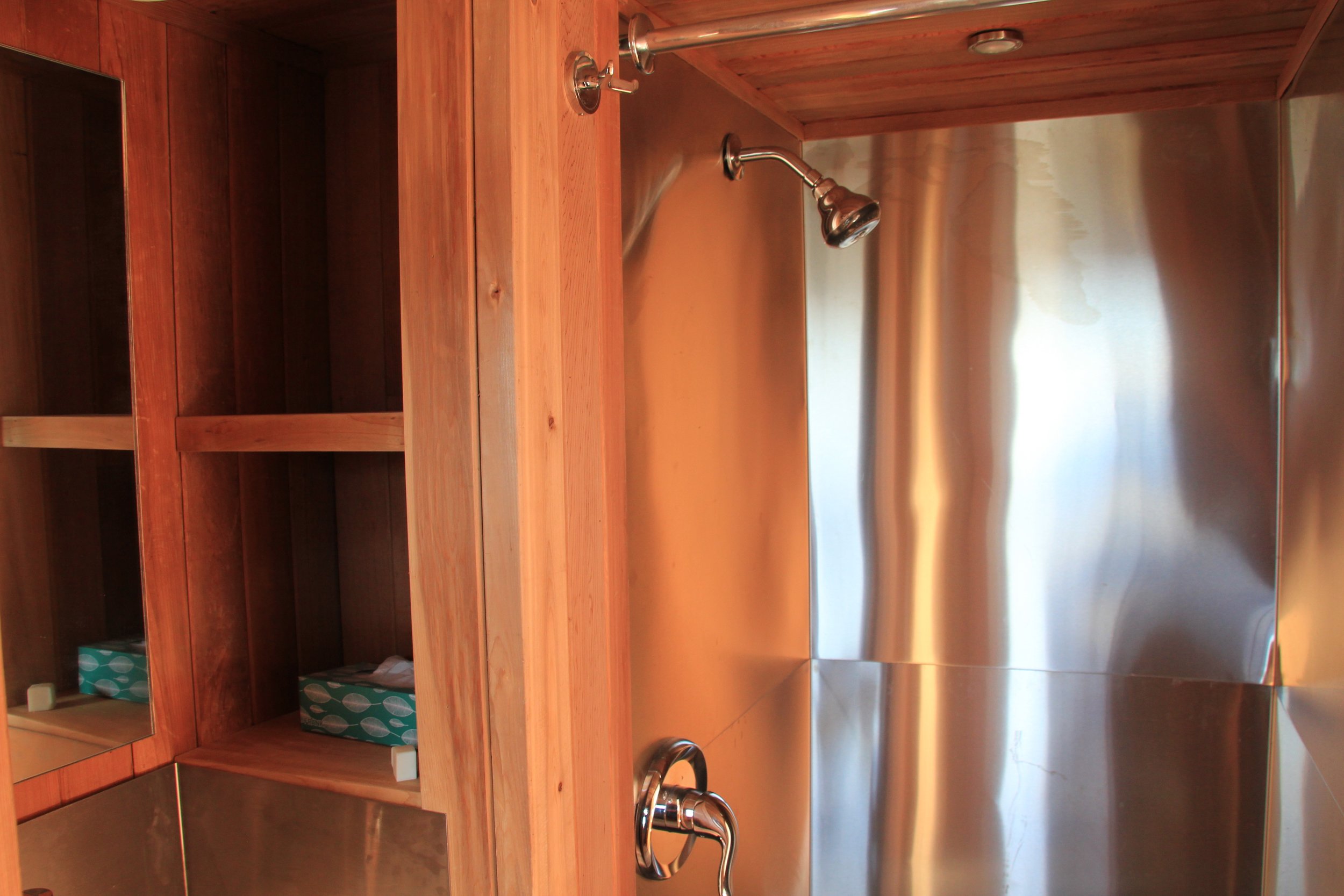 Deep shelves for storage beside the bathroom mirror.