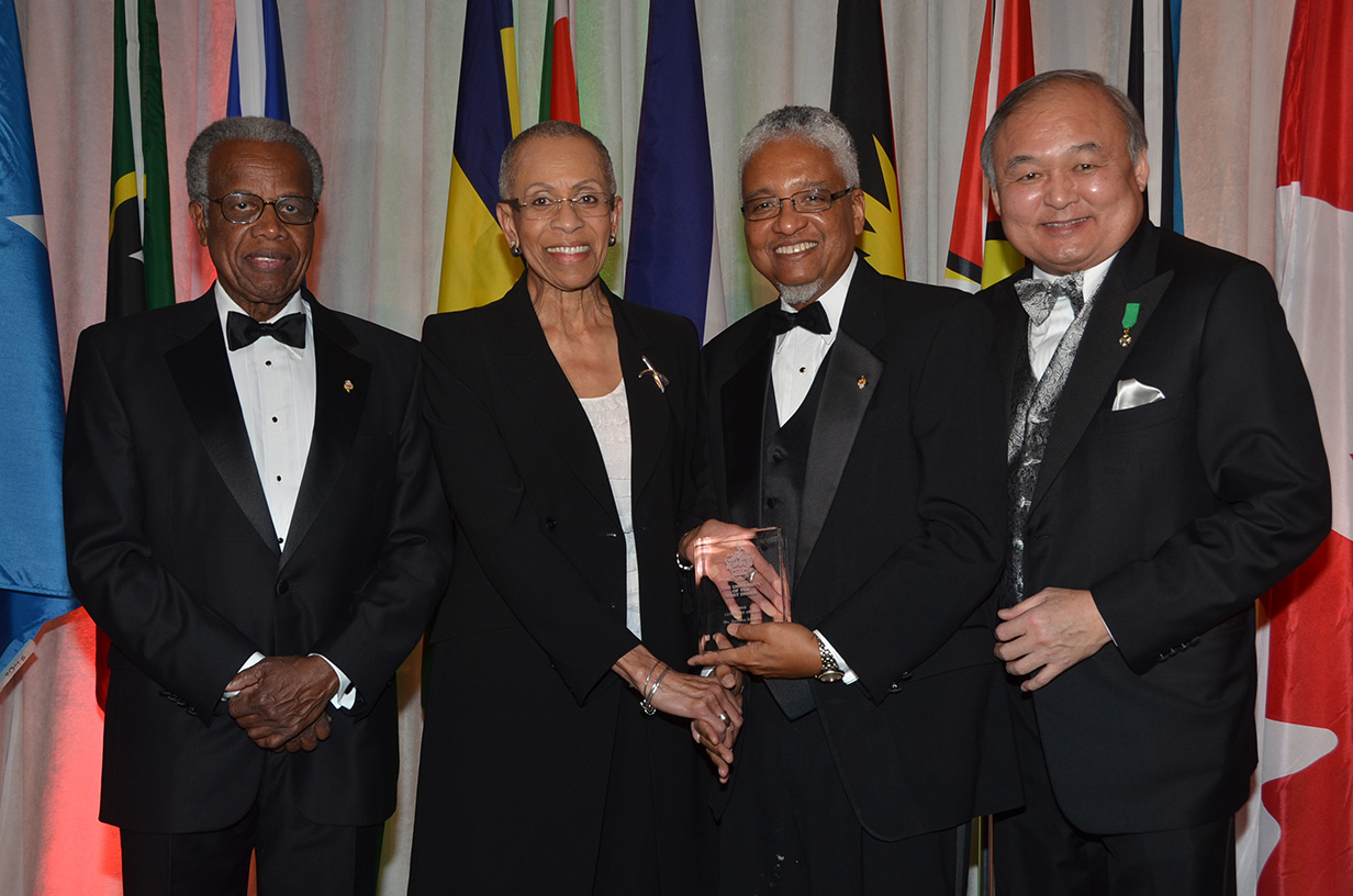 Zanana Akande receives UWI vice-chancellor award from Dr. Nigel Harris in the presence of Ray Chang and Sir George Alleyne