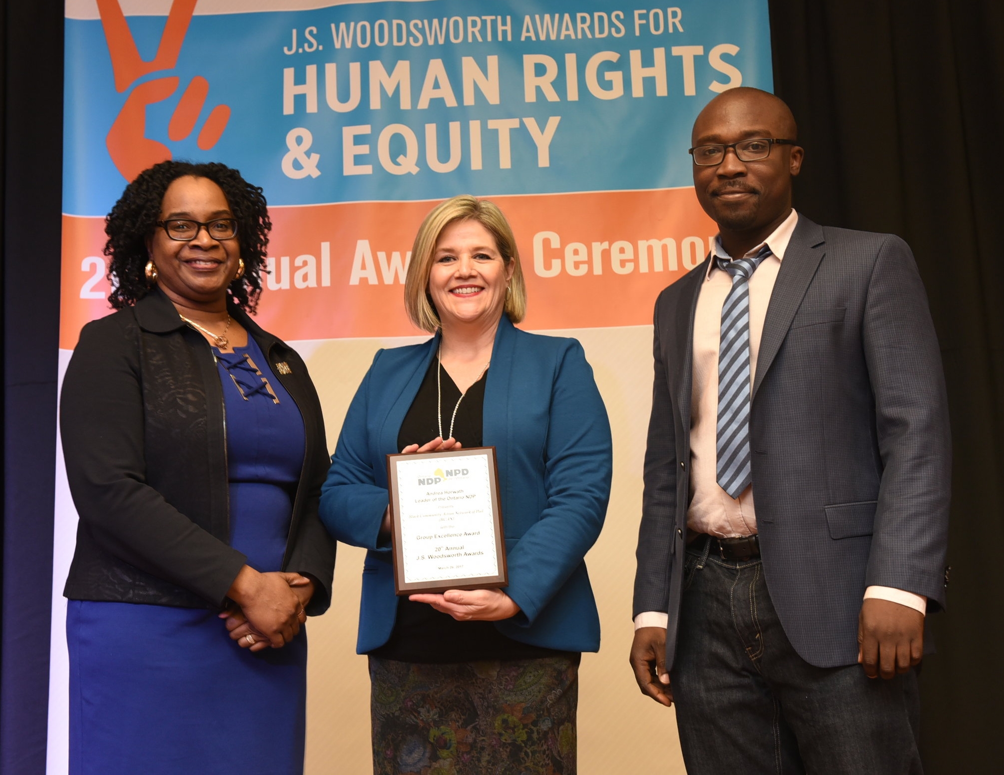 Suzette Nurse (l) and Dr. Julian Hasford of the BCAN received the Group Excellence Award from Andrea Horwath