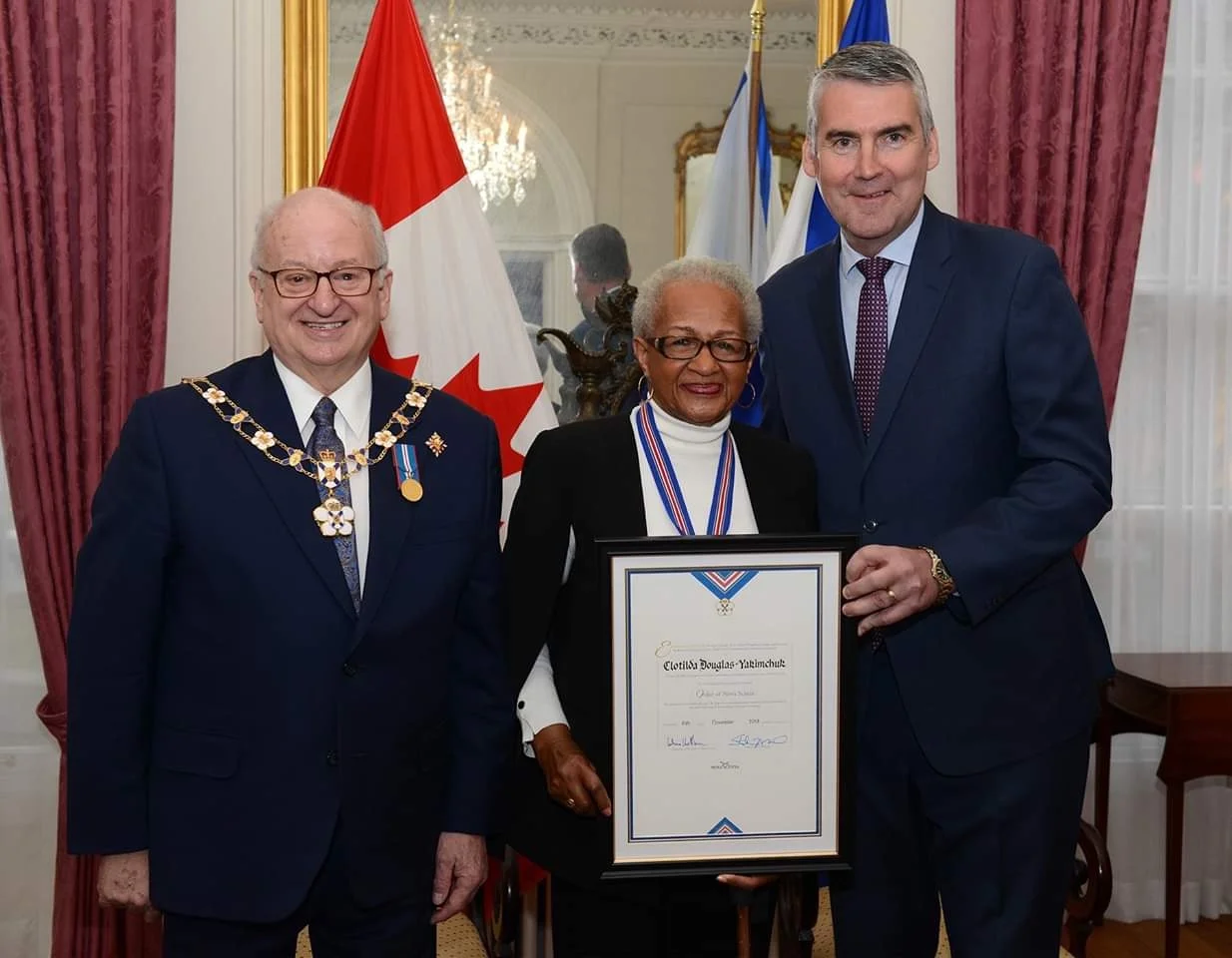 Nova Scotia premier Stephen McNeil (r) and governor general Arthur LeBlanc presented the Order of Nova Scotia to Clotilda Douglas-Yakimchuk