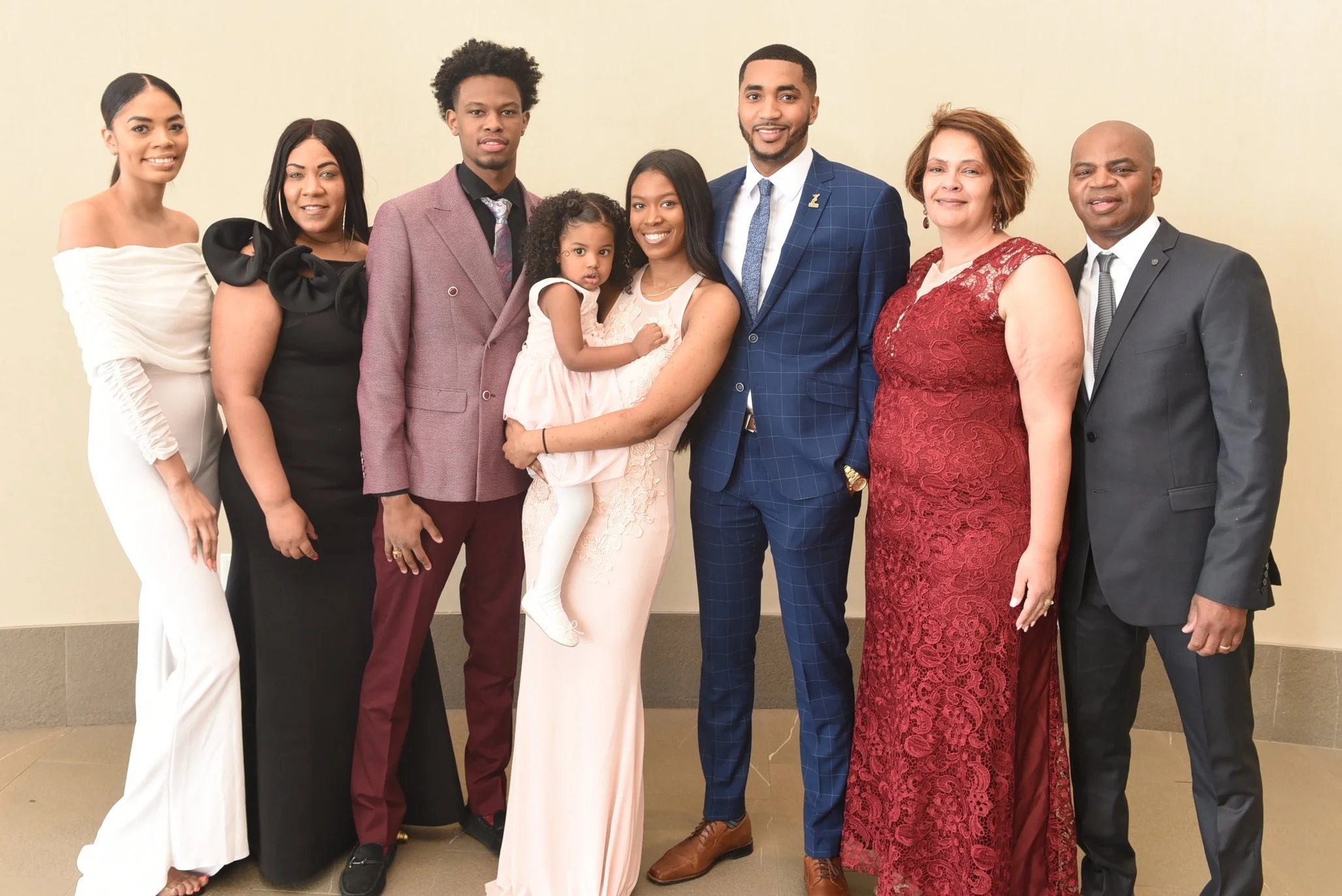 Shaquille Smith and his partner Janessa Tynes with their daughter Zaila surrounded by family members Jasmine Smith (l), Venessa Simmonds and his parents Christine & Gerald Smith