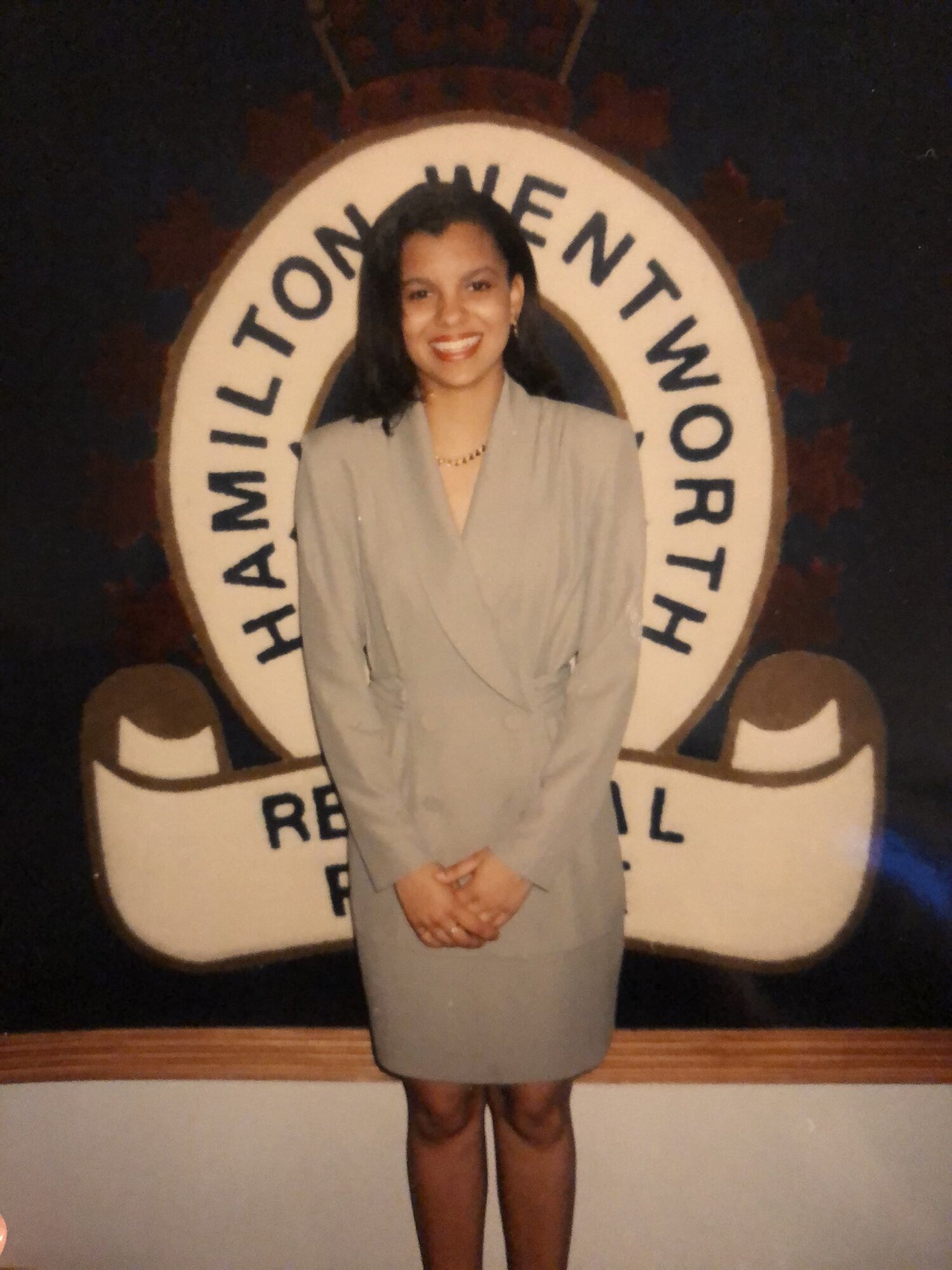 Treena MacSween in 1993  standing in front of the Hamilton Police Central Station logo rug which is outside her office (Photo contributed)