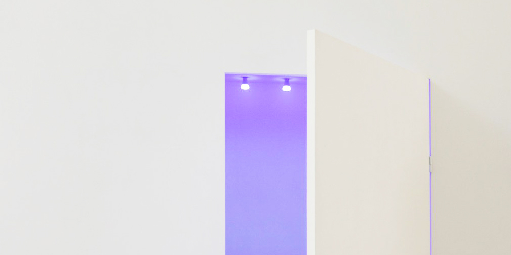 Chromophobia concept: A white door opening into a coloured space