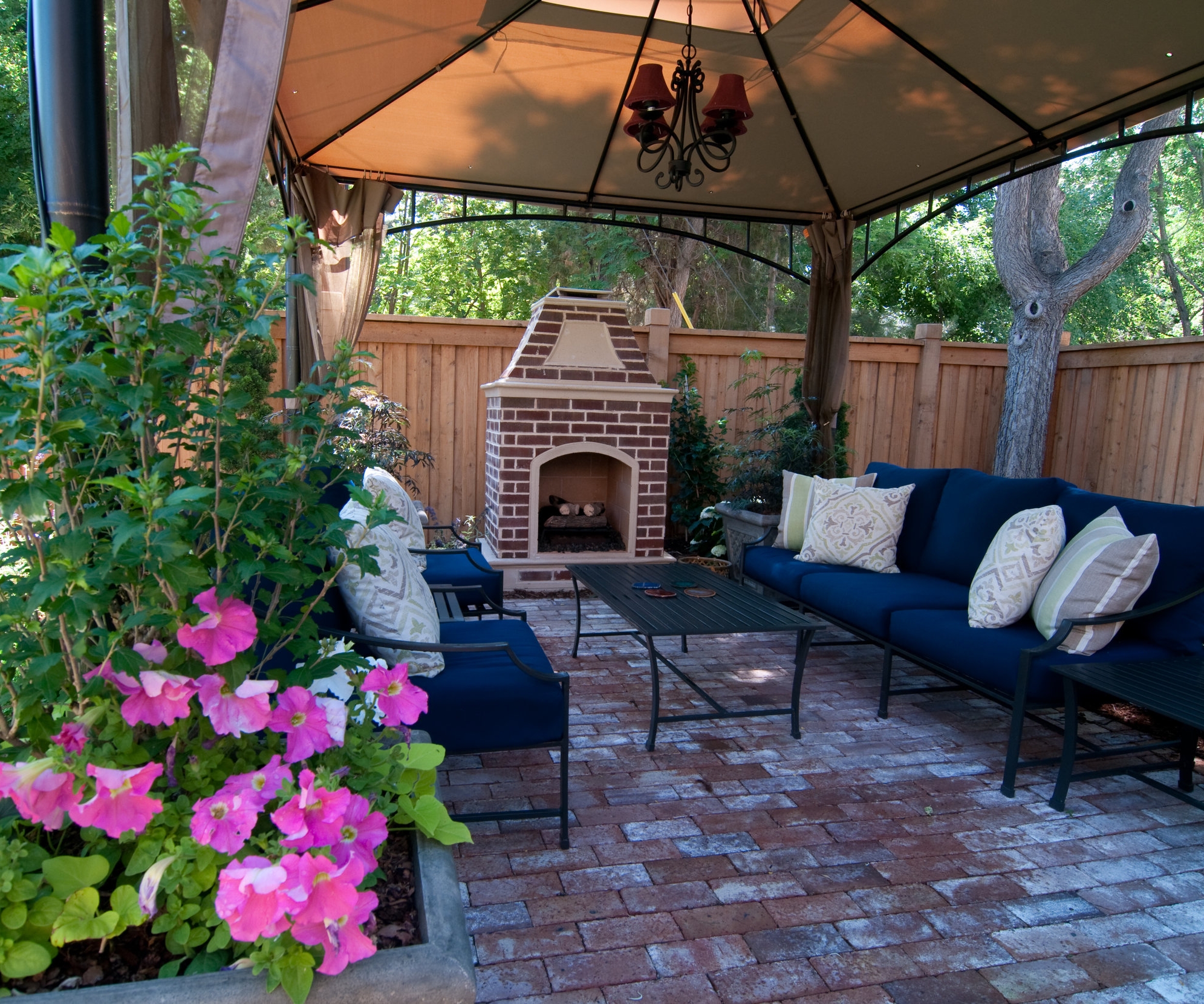 An outdoor room with permeable paving complete with outdoor gas fireplace and chandelier is fit for an English king!
