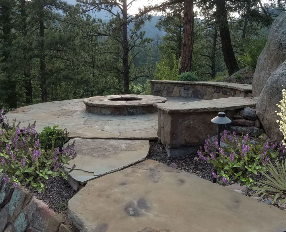 Firepit and seating is perched on the edge of the mountainside for dramatic views