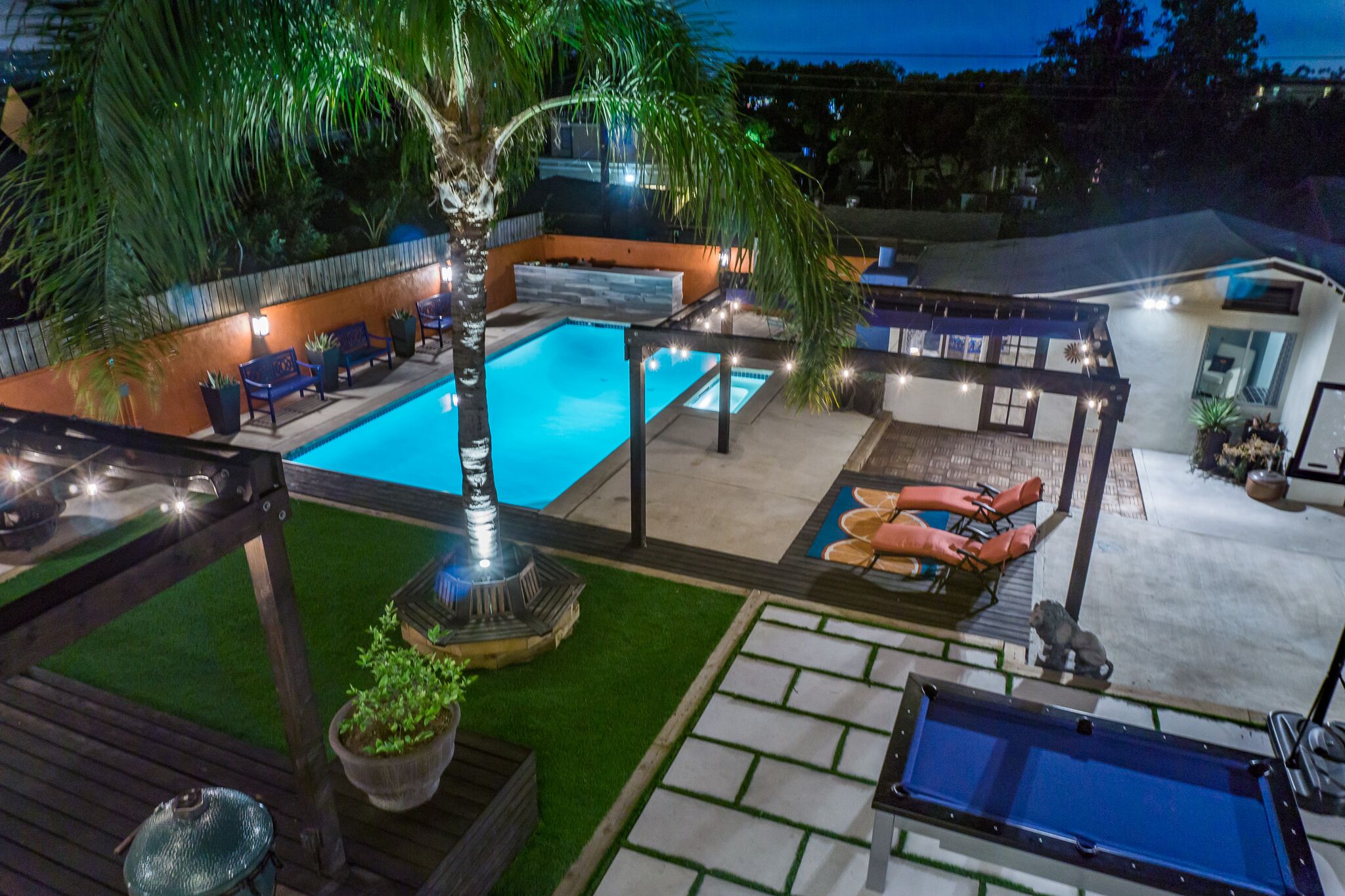 VIEW FROM THE UPSTAIRS BALCONY OF DECK / PATIO OUTDOOR LIVING AND GAMES AREAS