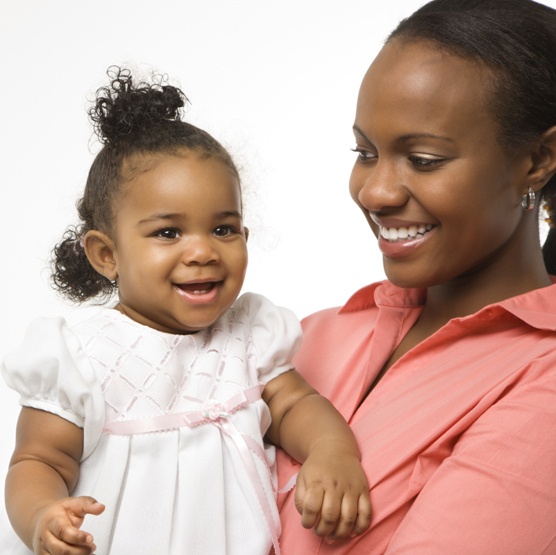 Woman holding infant girl.