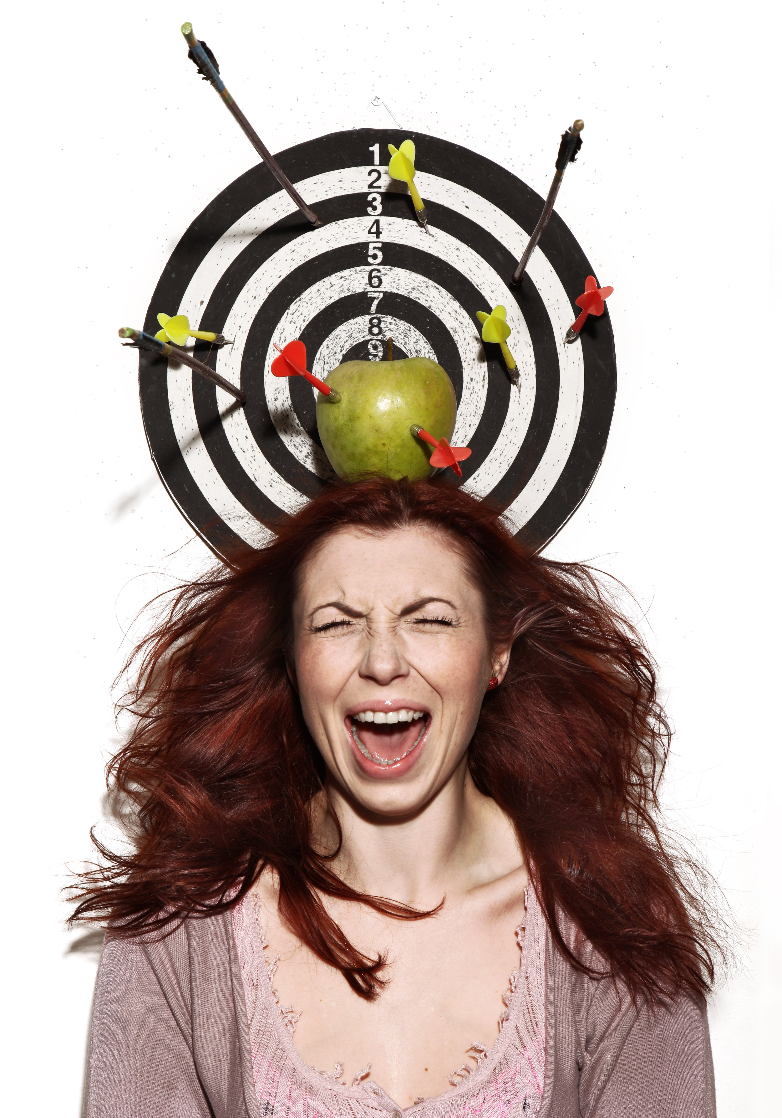 crying girl portrait with apple, darts and arrows