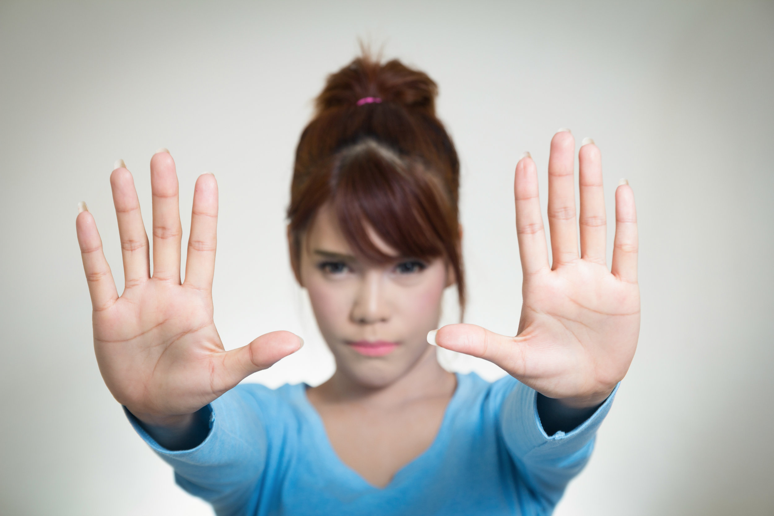 Asian women showing stop gesture