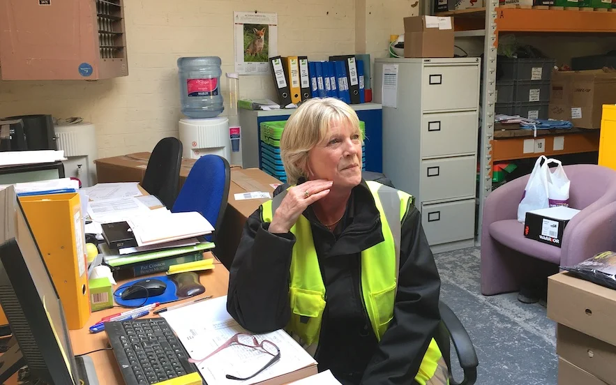 Ann White, the pin-up for older workers, at her desk
