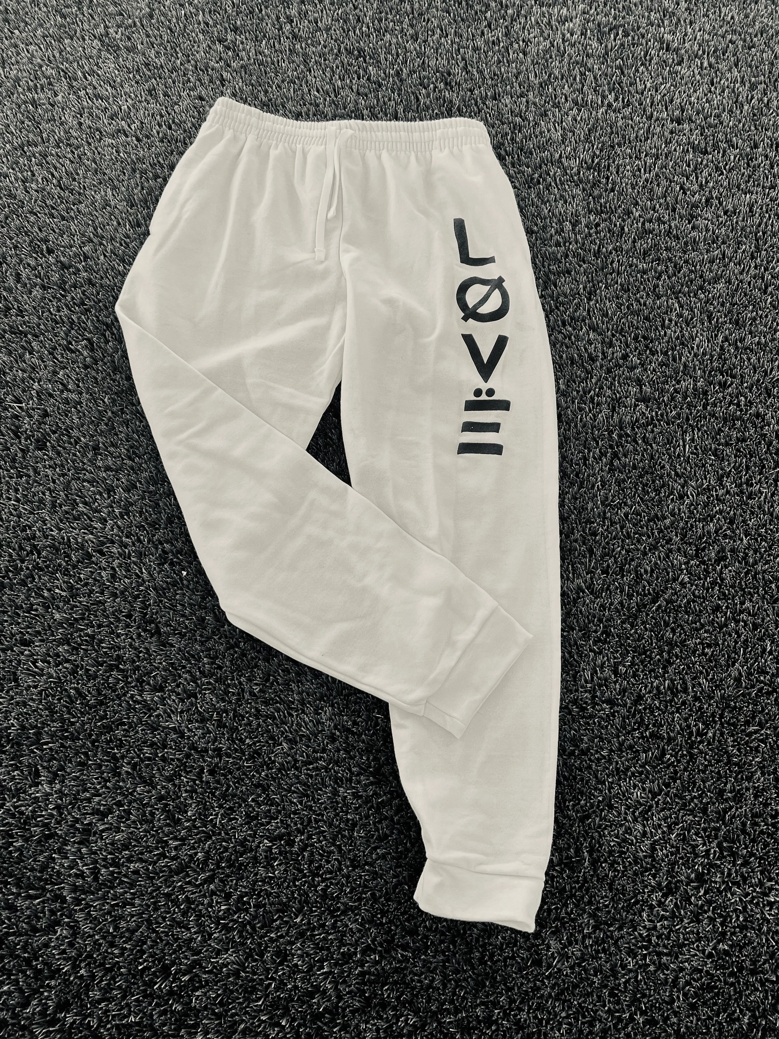 White joggers with black love logo
