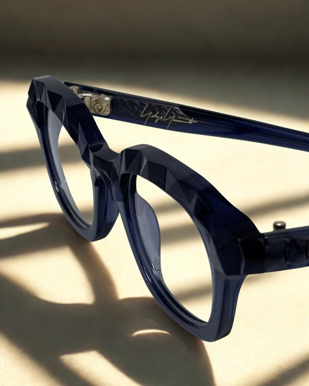 There's a technique used in gemstone cutting that @yohjiyamamotoeyewear applied to this frame

The facets &mdash; the geometric planes that cover the entire frame surface &mdash; aren't decorative. They're three-dimensional. The acetate itself is sha