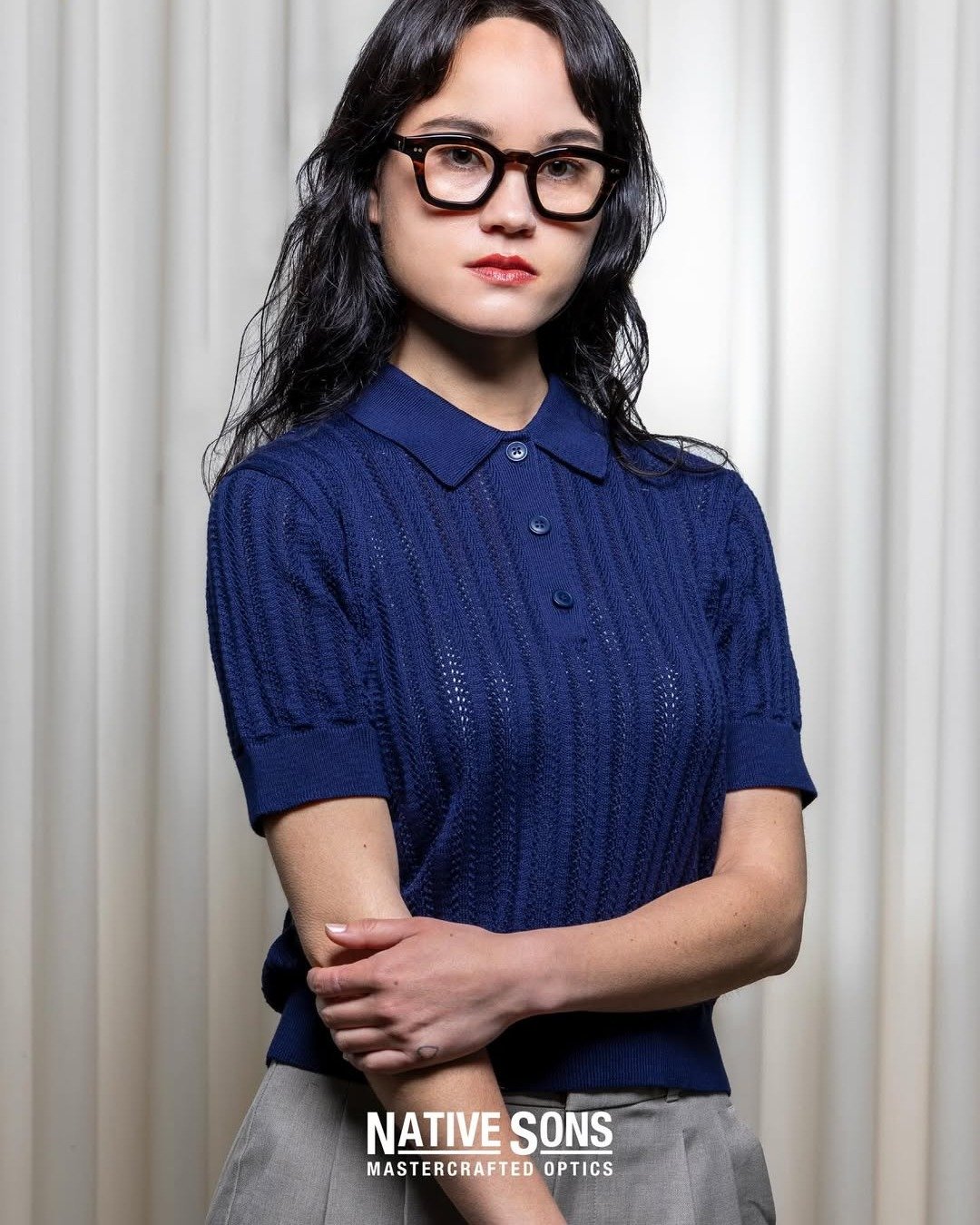 She already knew. The frame just made it visible. 👁️

The gaze. The crossed arms. The navy and the grey and the tortoise that sits on the face with complete authority.

None of this was assembled. It arrived.

Native Sons Mastercrafted Optics &mdash